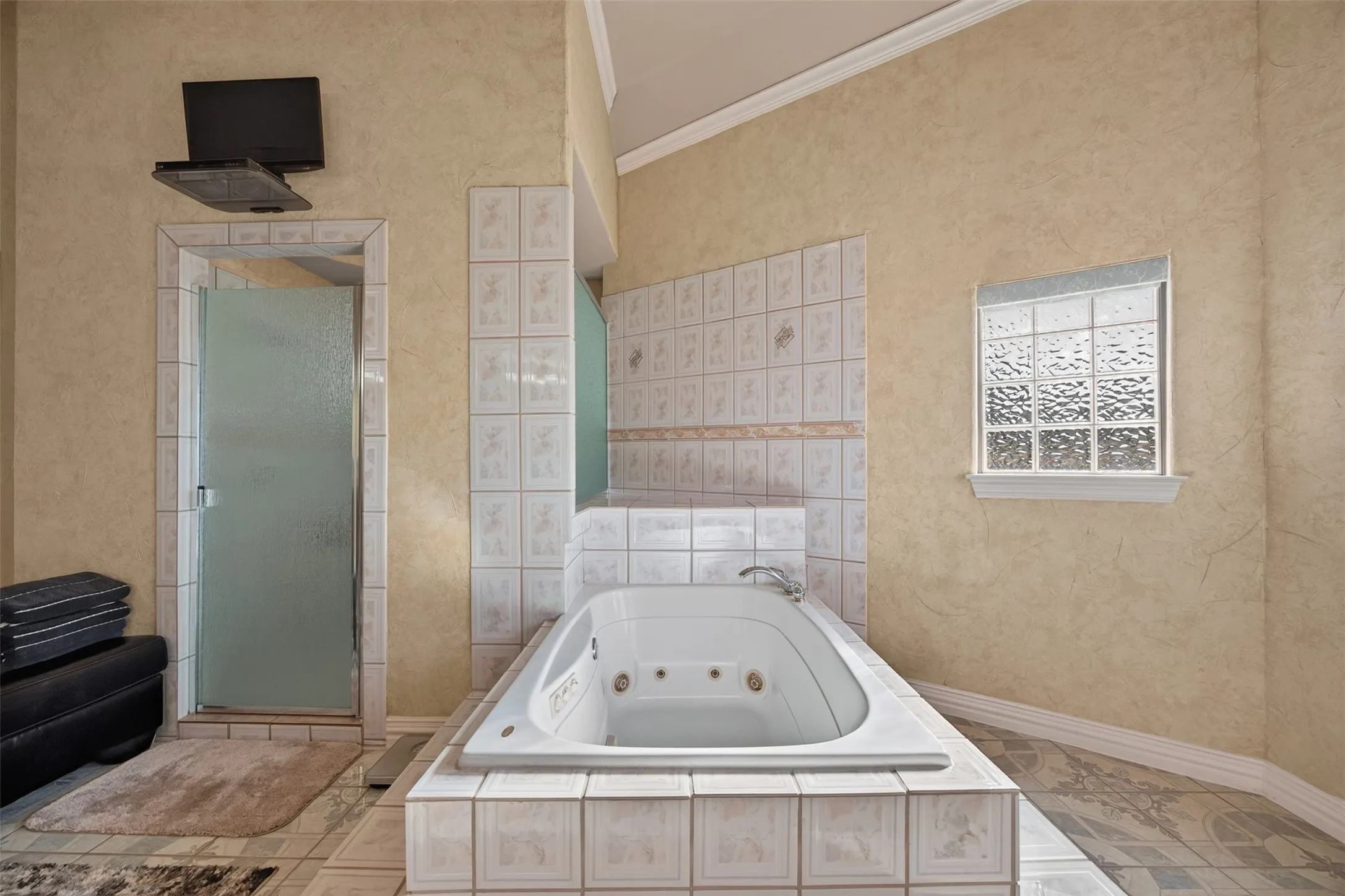 Spacious spa-like primary bathroom with jetted tub and overiszed separate shower with bench