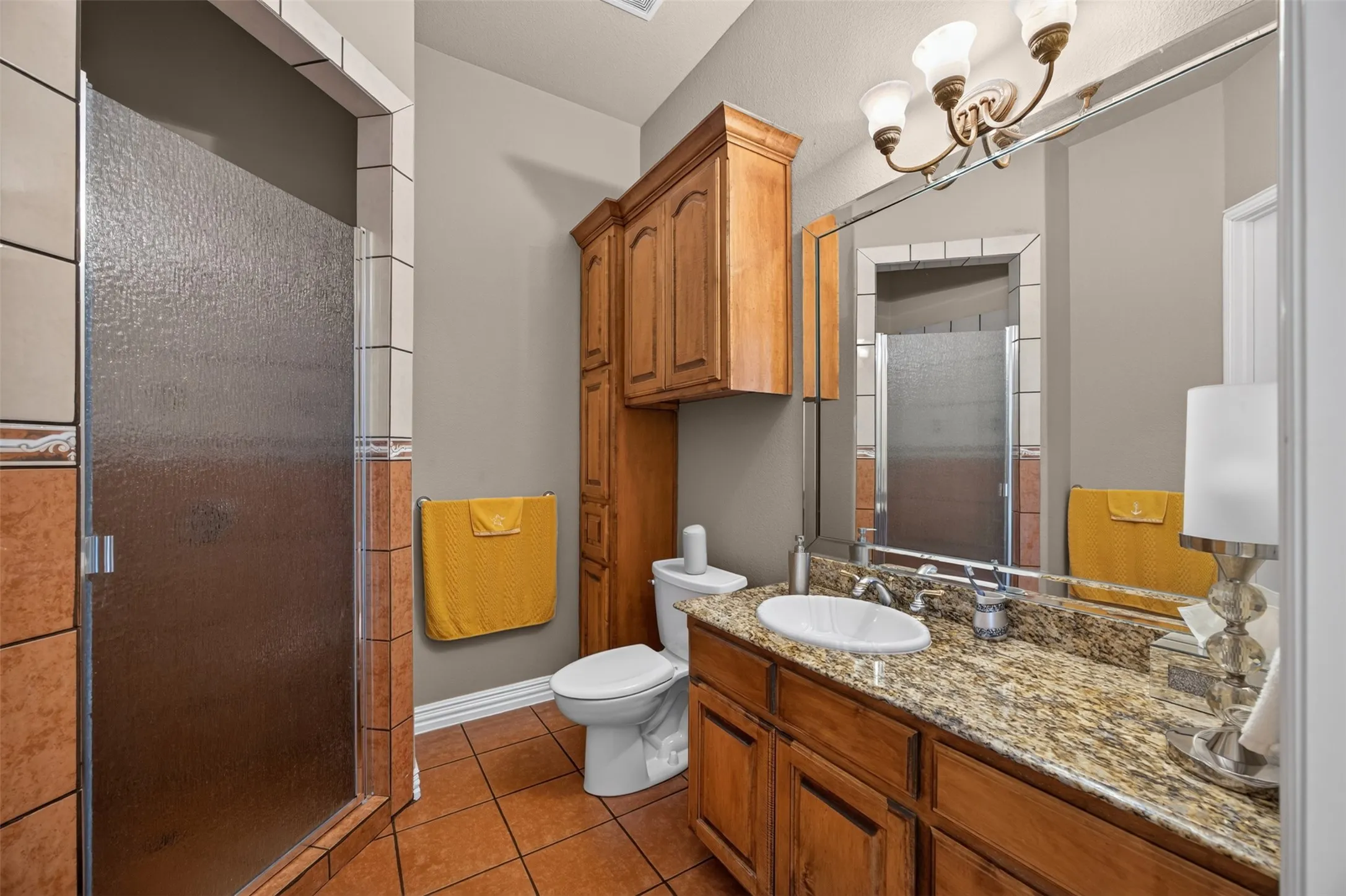 Ensuite bathroom with walk-in shower and built-in cabinetry
