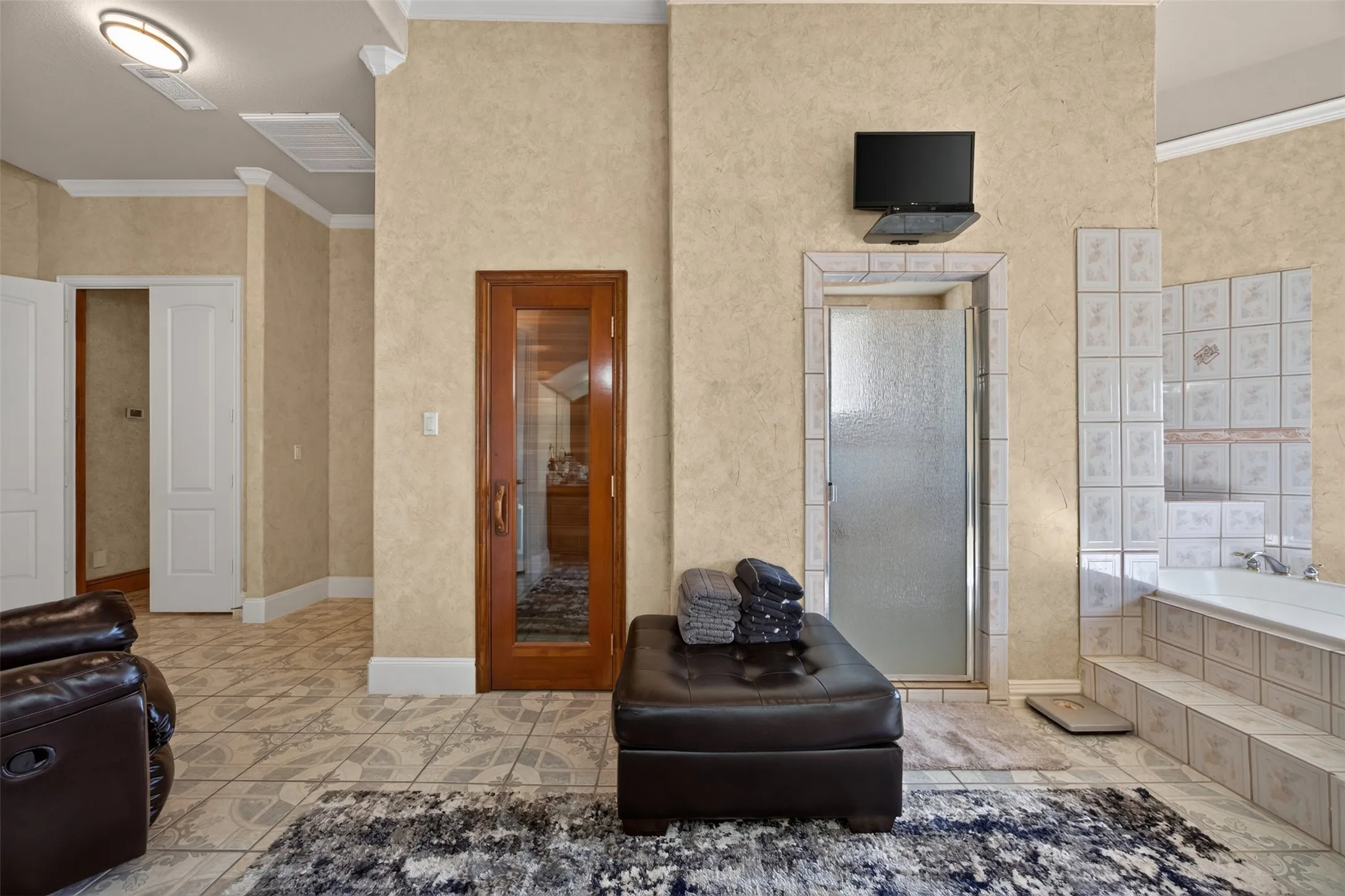 Spacious spa-like primary bathroom with built-in spa, jetted tub and overisized separate shower with bench