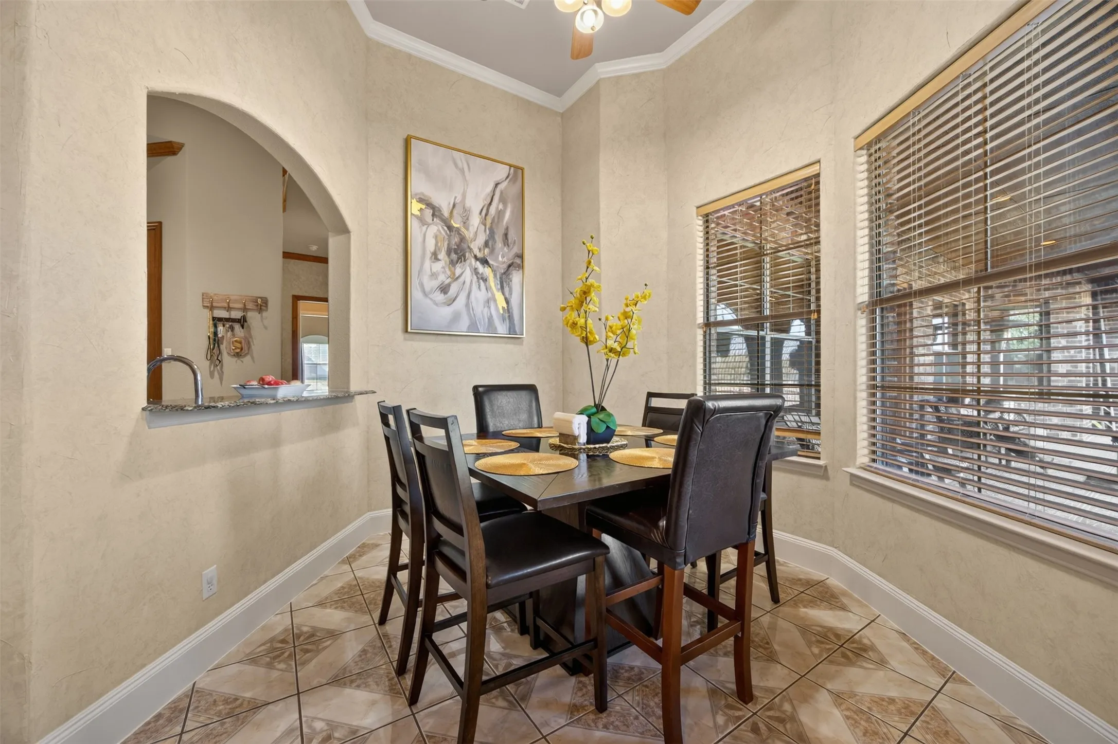 Breakfast nook with bar and ceiling fan