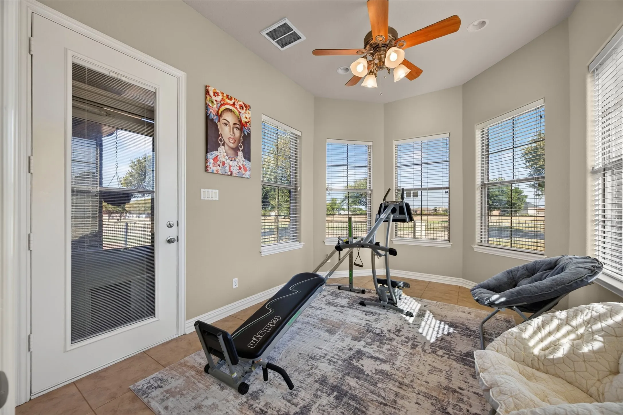 5th bedroom with patio access and ceiling fan