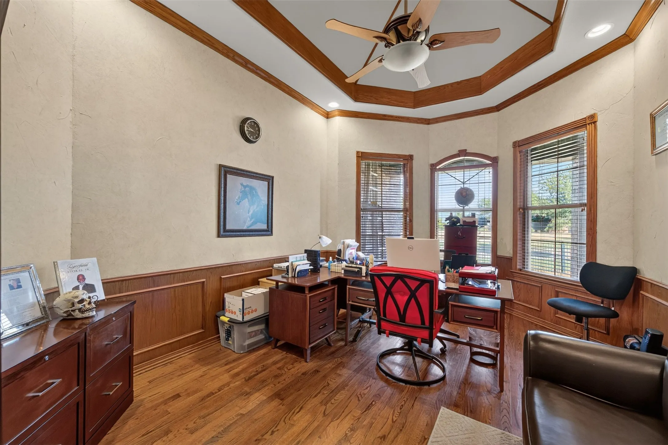 Office with French doors, hardwood floors, vaulted ceiling, ceiling fan.