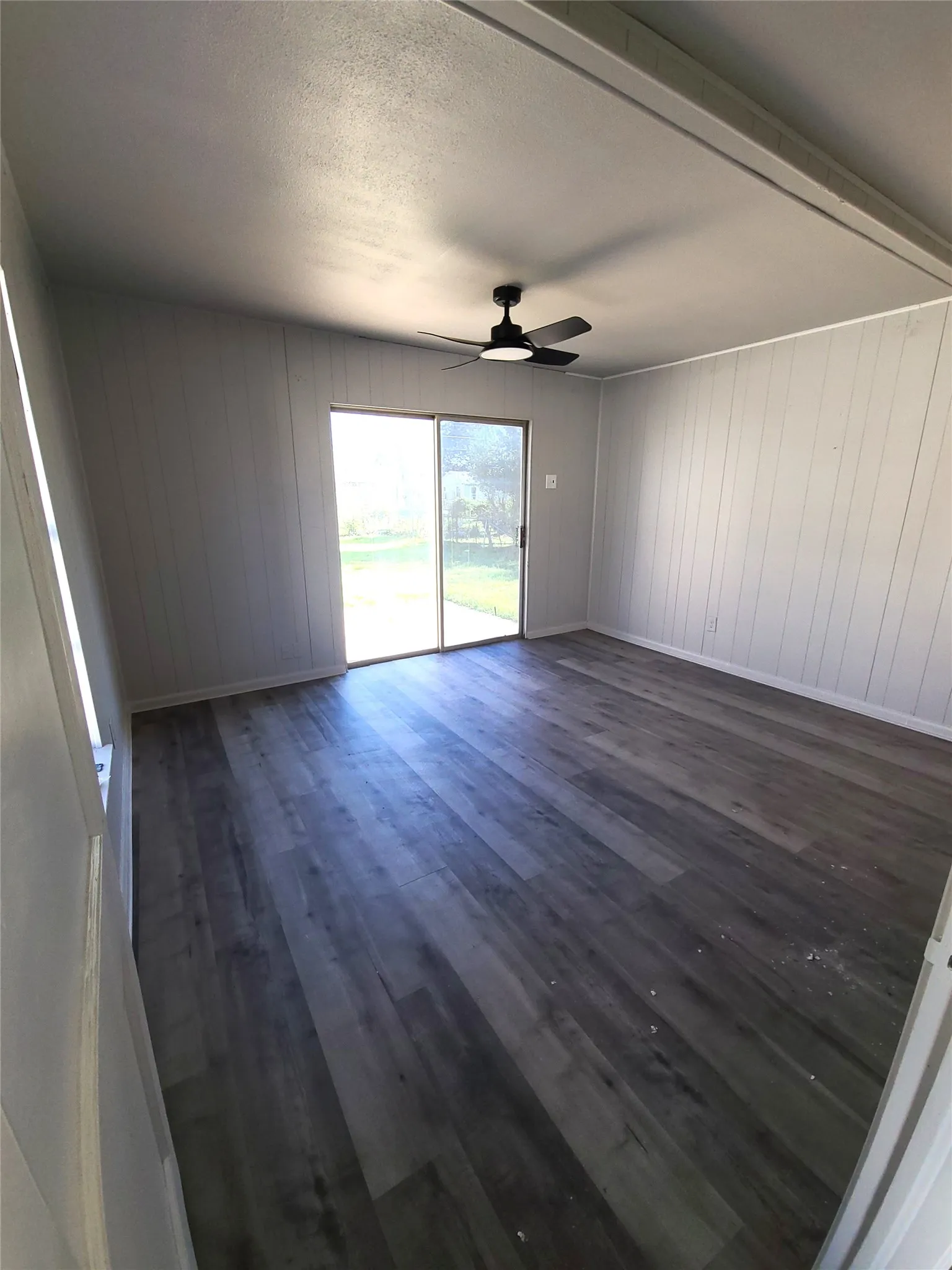 Large Primary Suite with patio doors leading to the backyard patio.