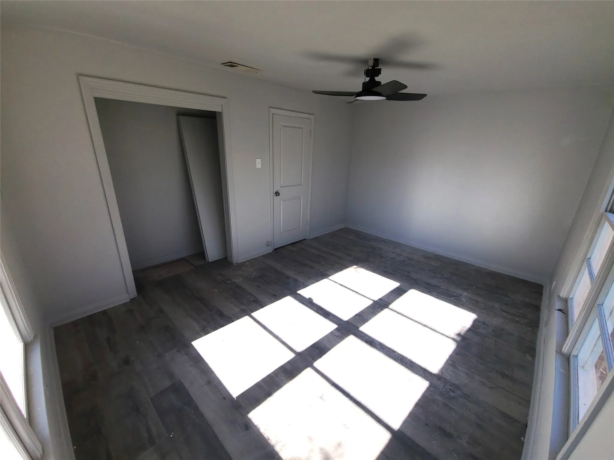 bedroom #4 featuring dark wood-style floors, a ceiling fan, and a closet
