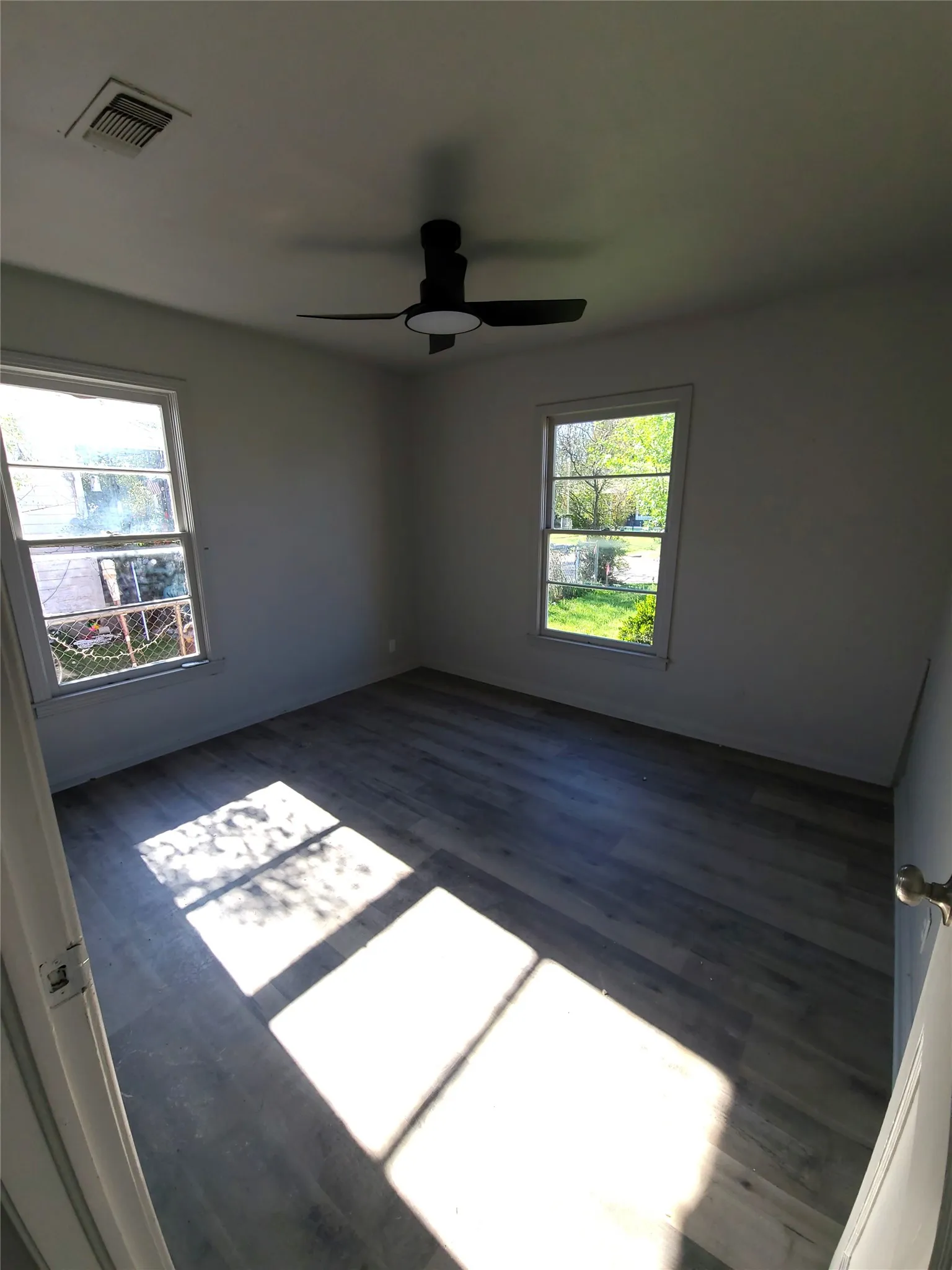 Bedroom#2 with dark wood-style flooring, healthy amount of natural light, and ceiling fan