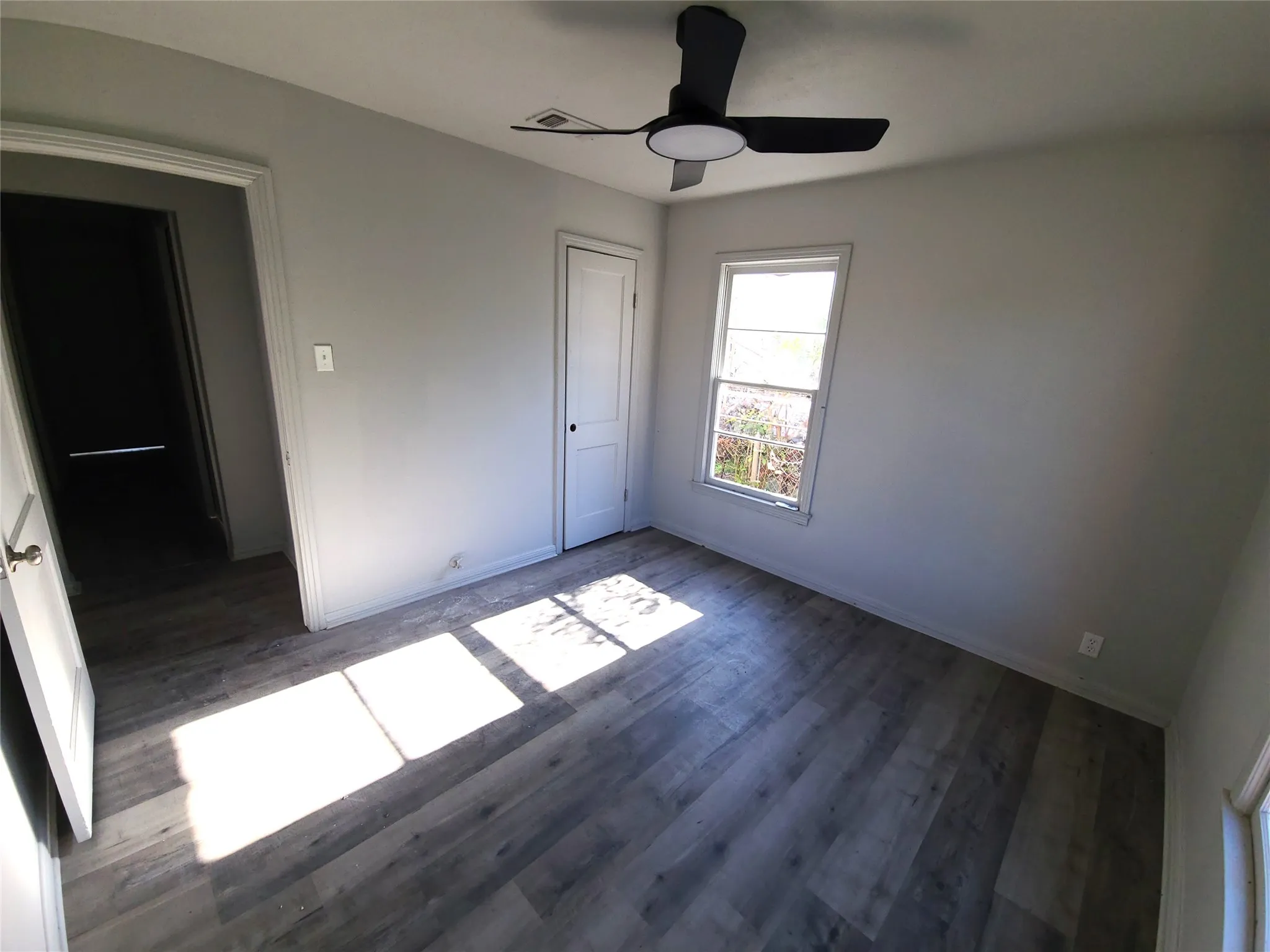 Bedroom #2 with dark wood finished floors, ceiling fan, and a closet