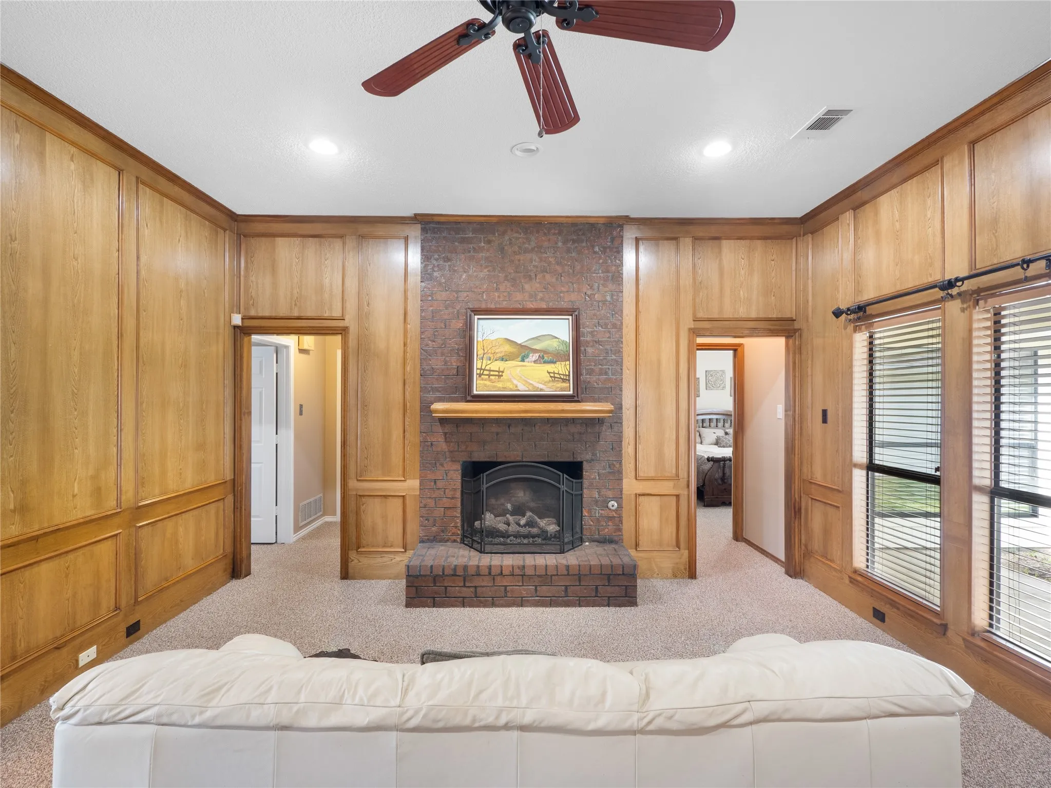 Recessed lighting, wood-finish cabinetry, built-in wall oven and microwave, skylight, and light-toned flooring