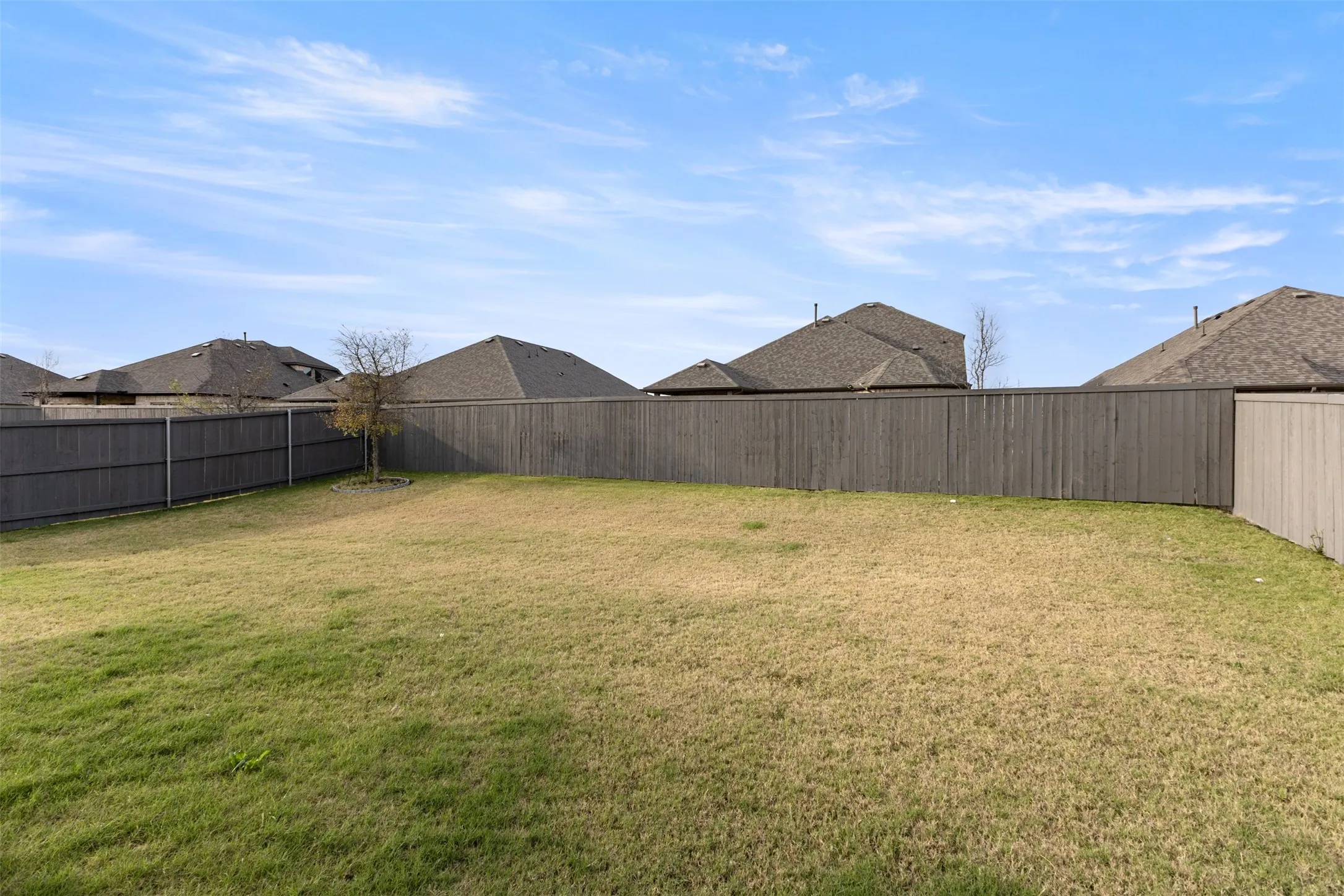 Fenced backyard with a residential view