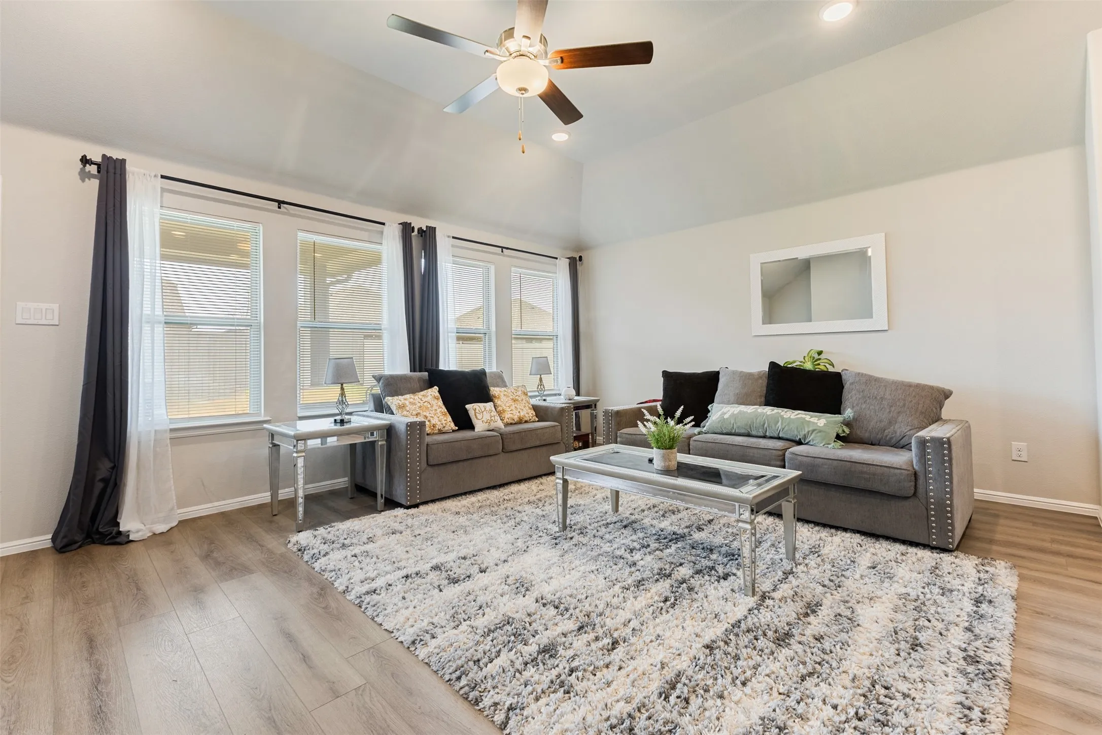 Living area with light wood-style floors, recessed lighting, lofted ceiling, and a ceiling fan