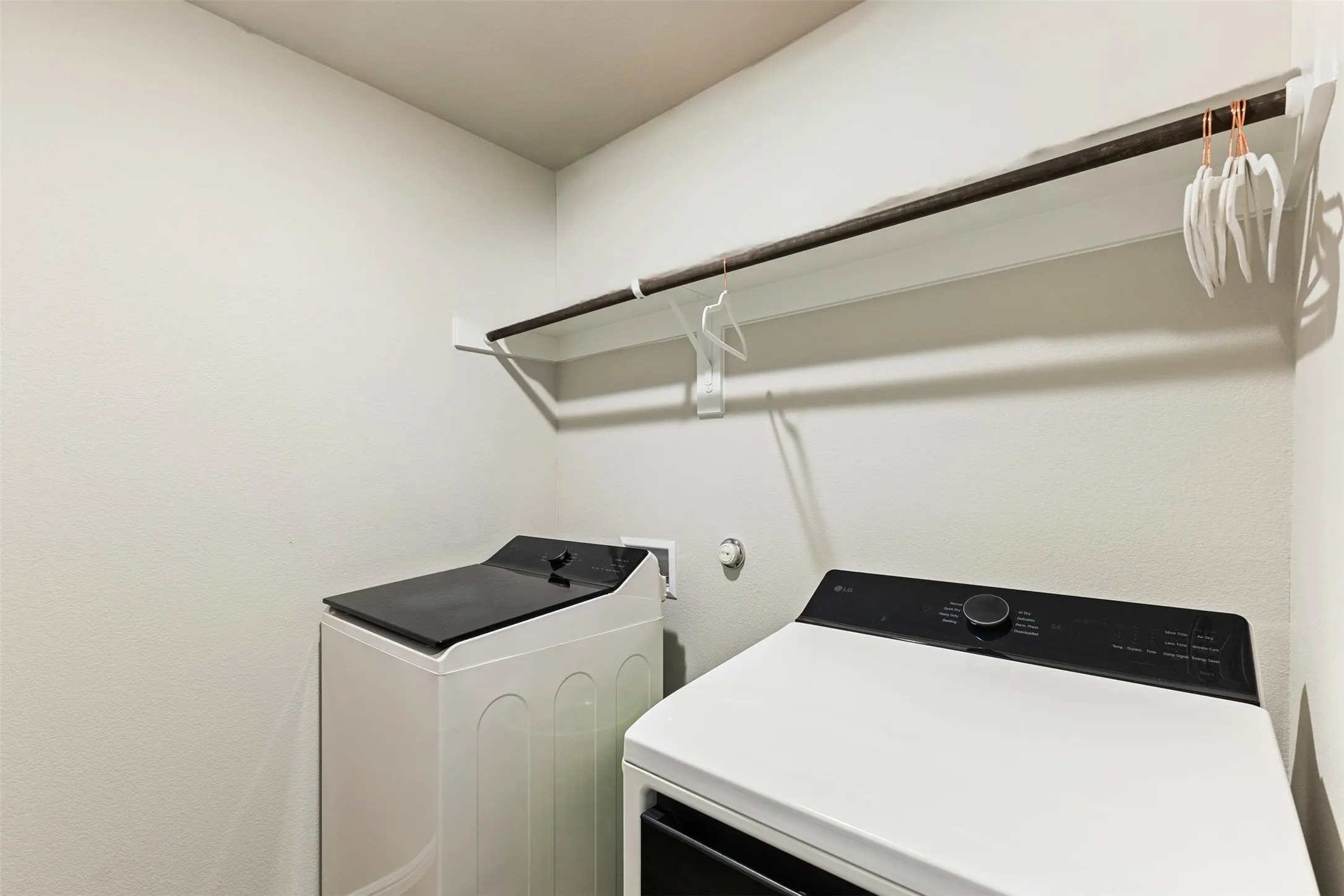 Washroom with washing machine and clothes dryer