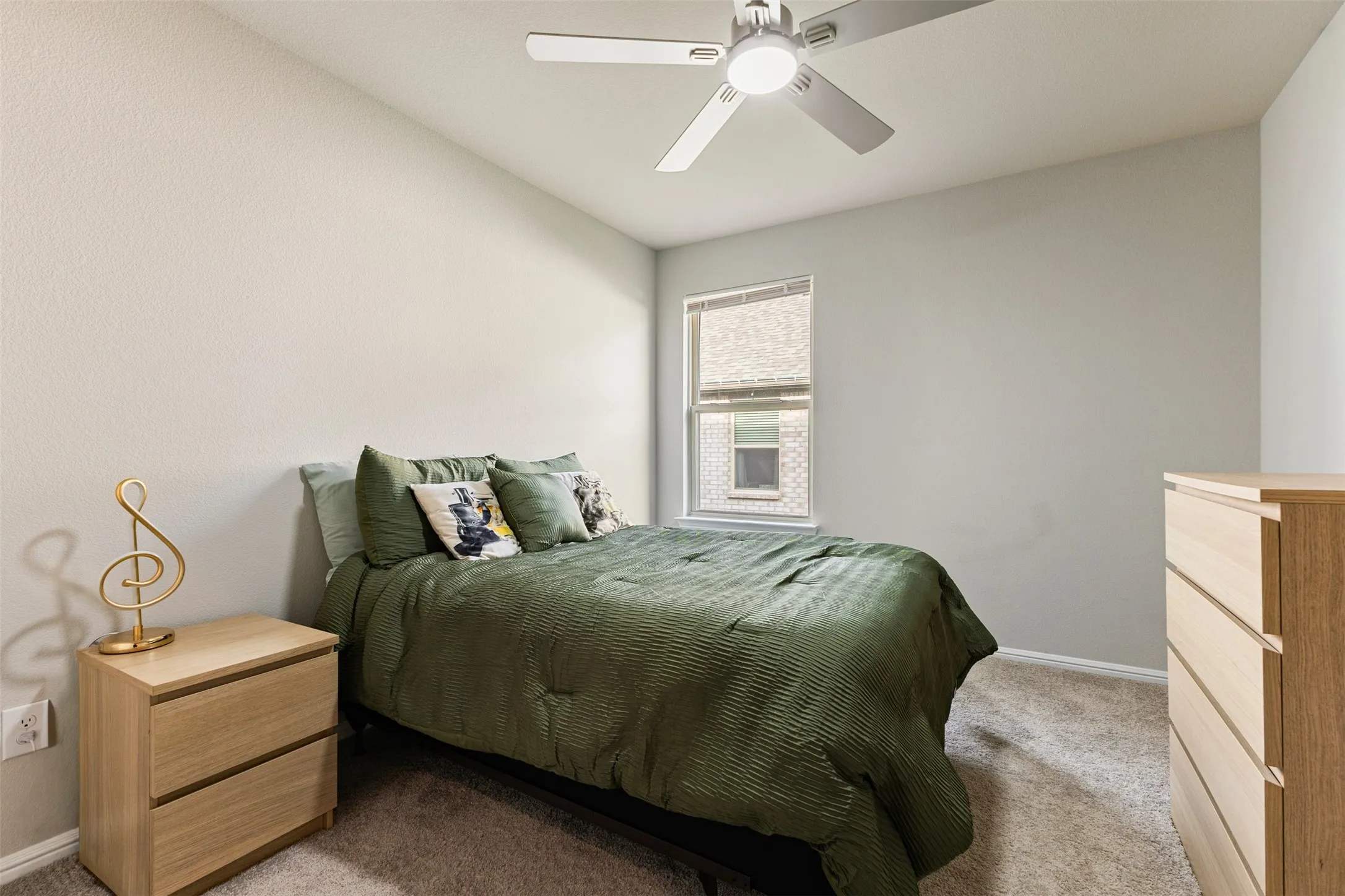 Bedroom featuring light colored carpet and ceiling fan