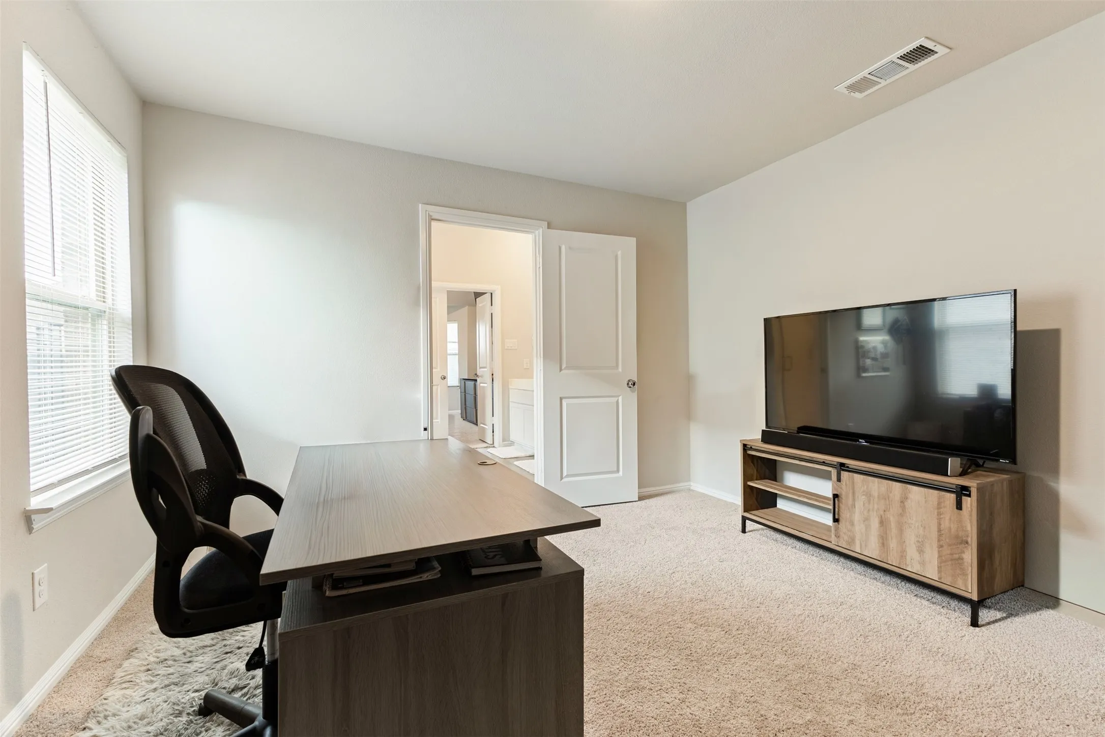 Home office featuring light colored carpet