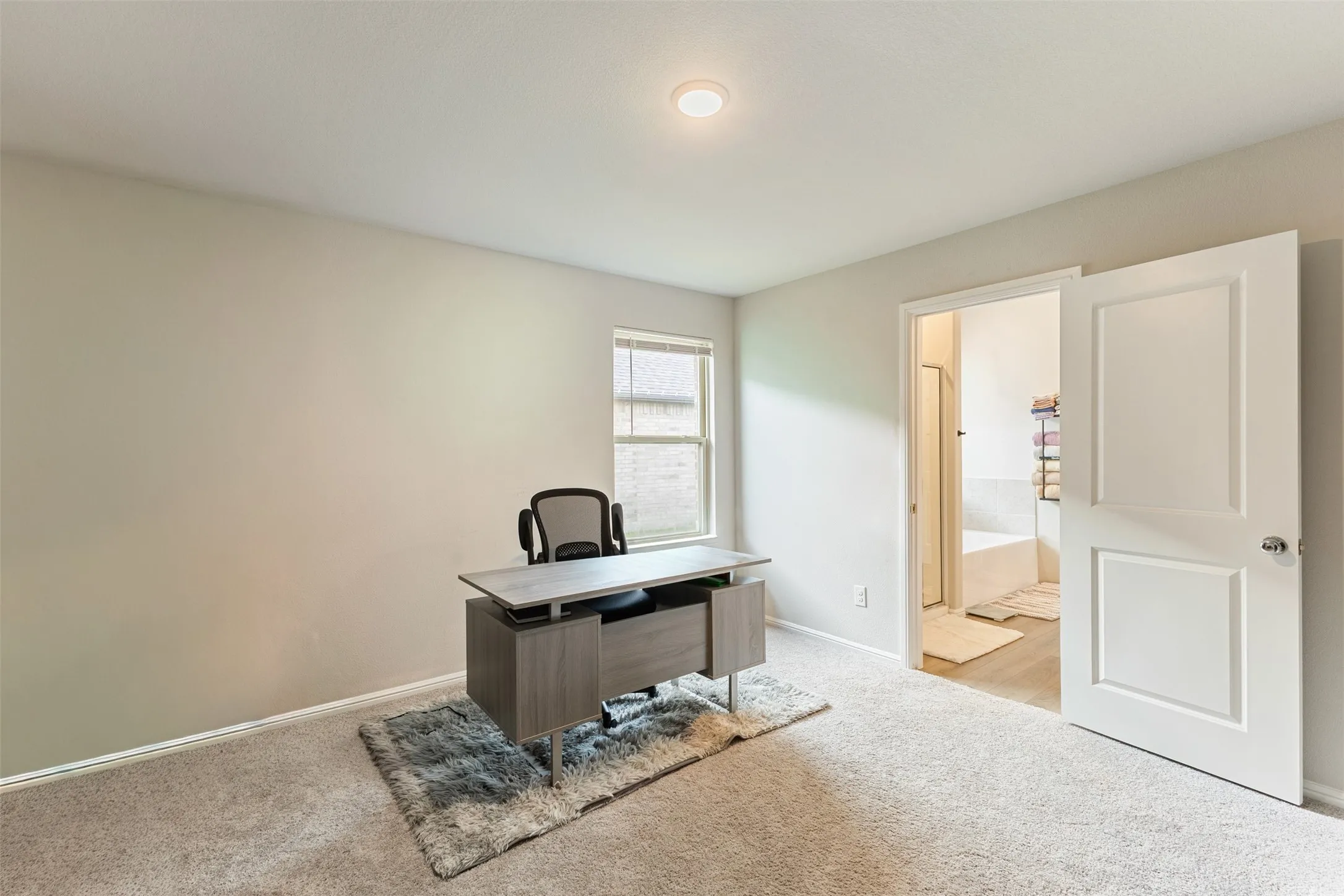 Home office with light carpet