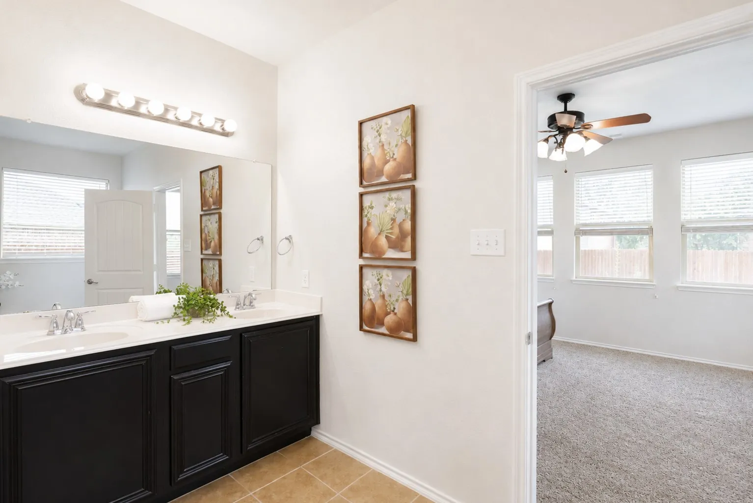 Dual vanity with white countertops, integrated sinks, and chrome faucets