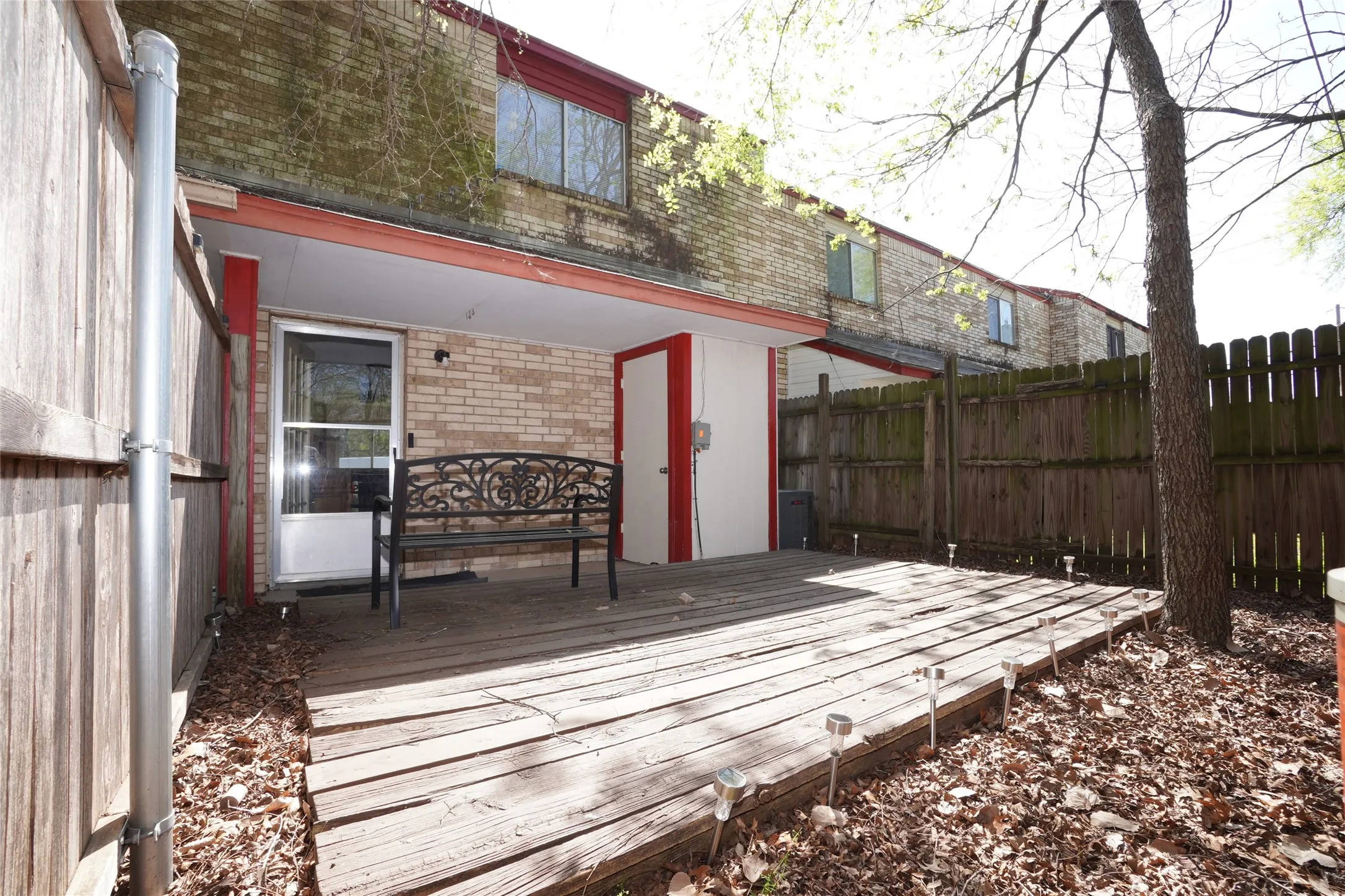 Brick exterior with a covered patio and direct access