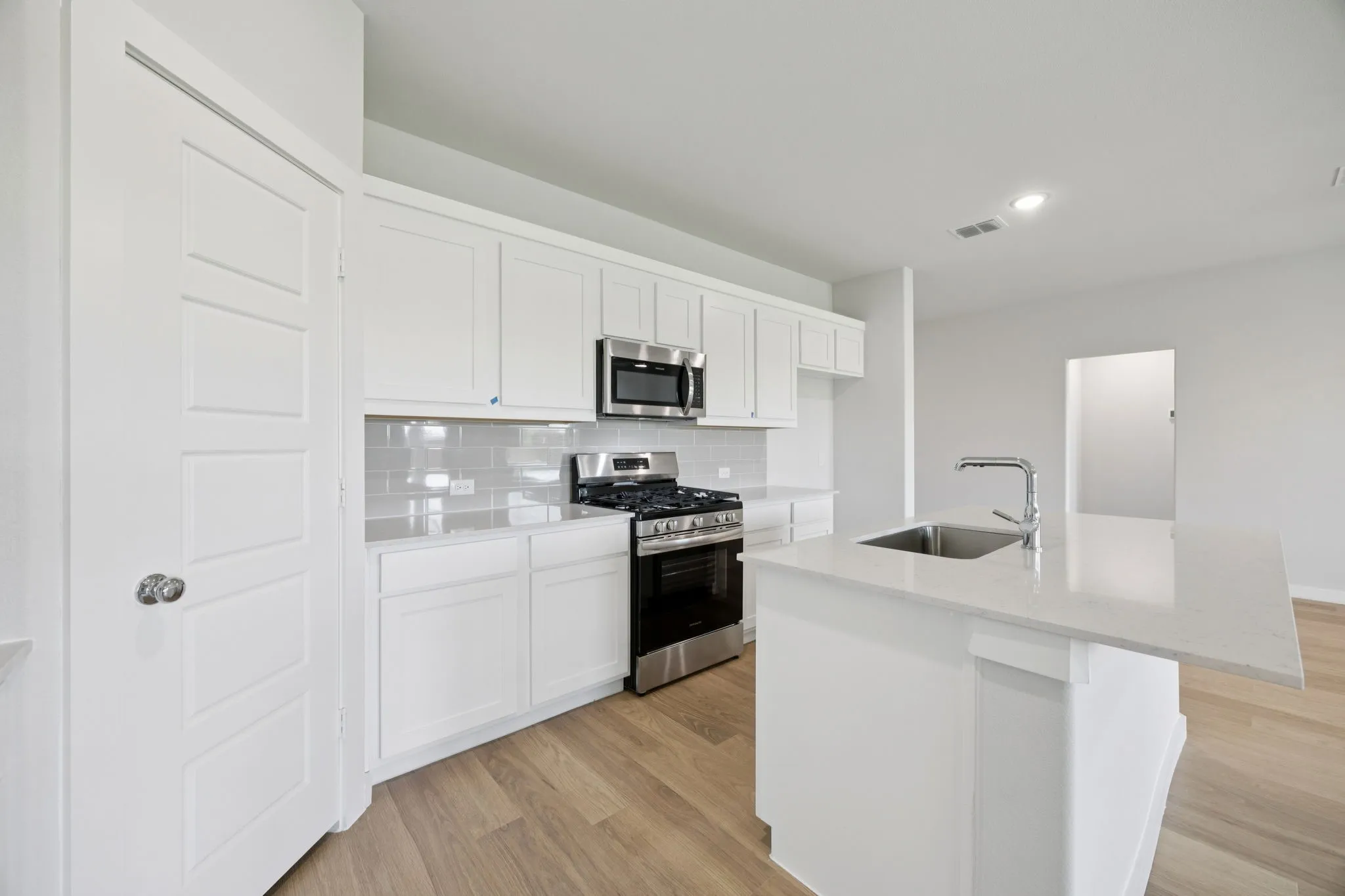 Kitchen in the Hadley home plan by Trophy Signature Homes – REPRESENTATIVE PHOTO