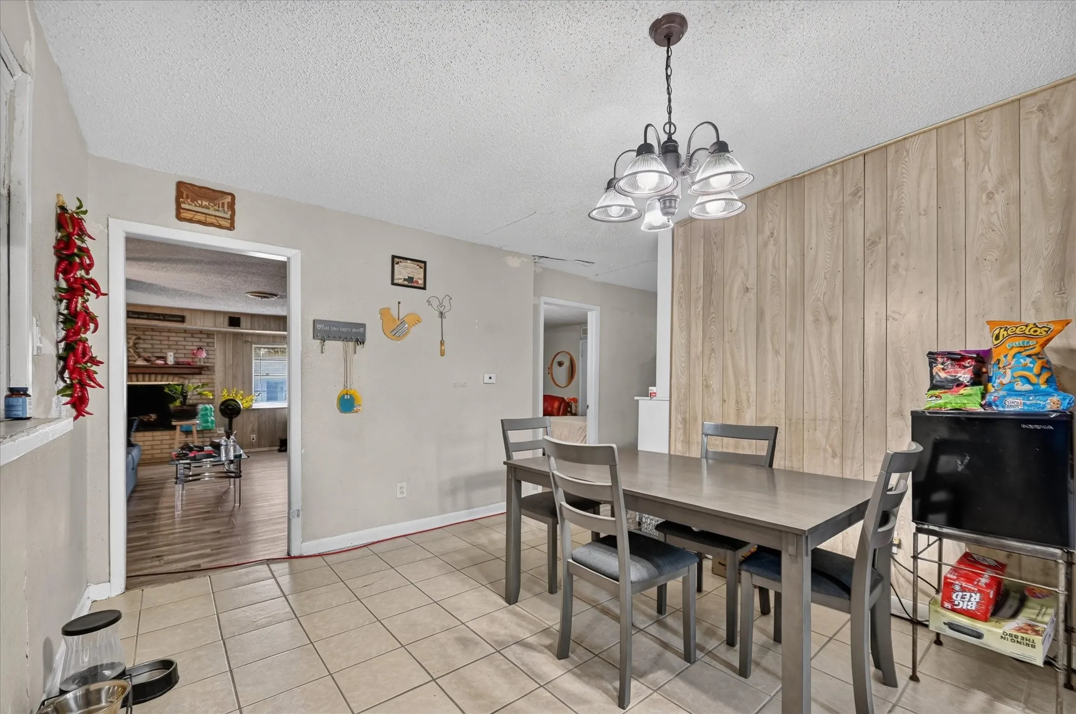 Tile flooring, recessed lighting, and a wood-paneled accent wall