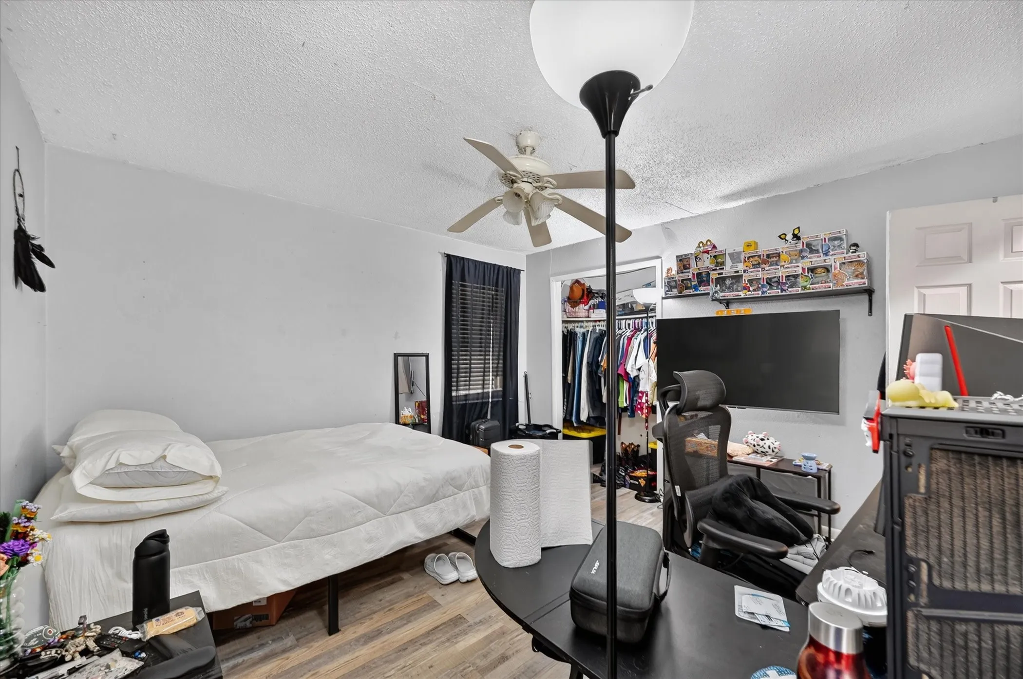 Wood-finish flooring with a ceiling fan light fixture