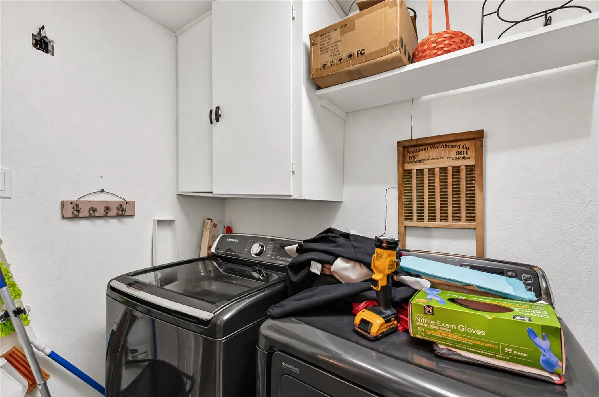 White wall-mounted cabinetry, integrated shelving, and dedicated appliance space