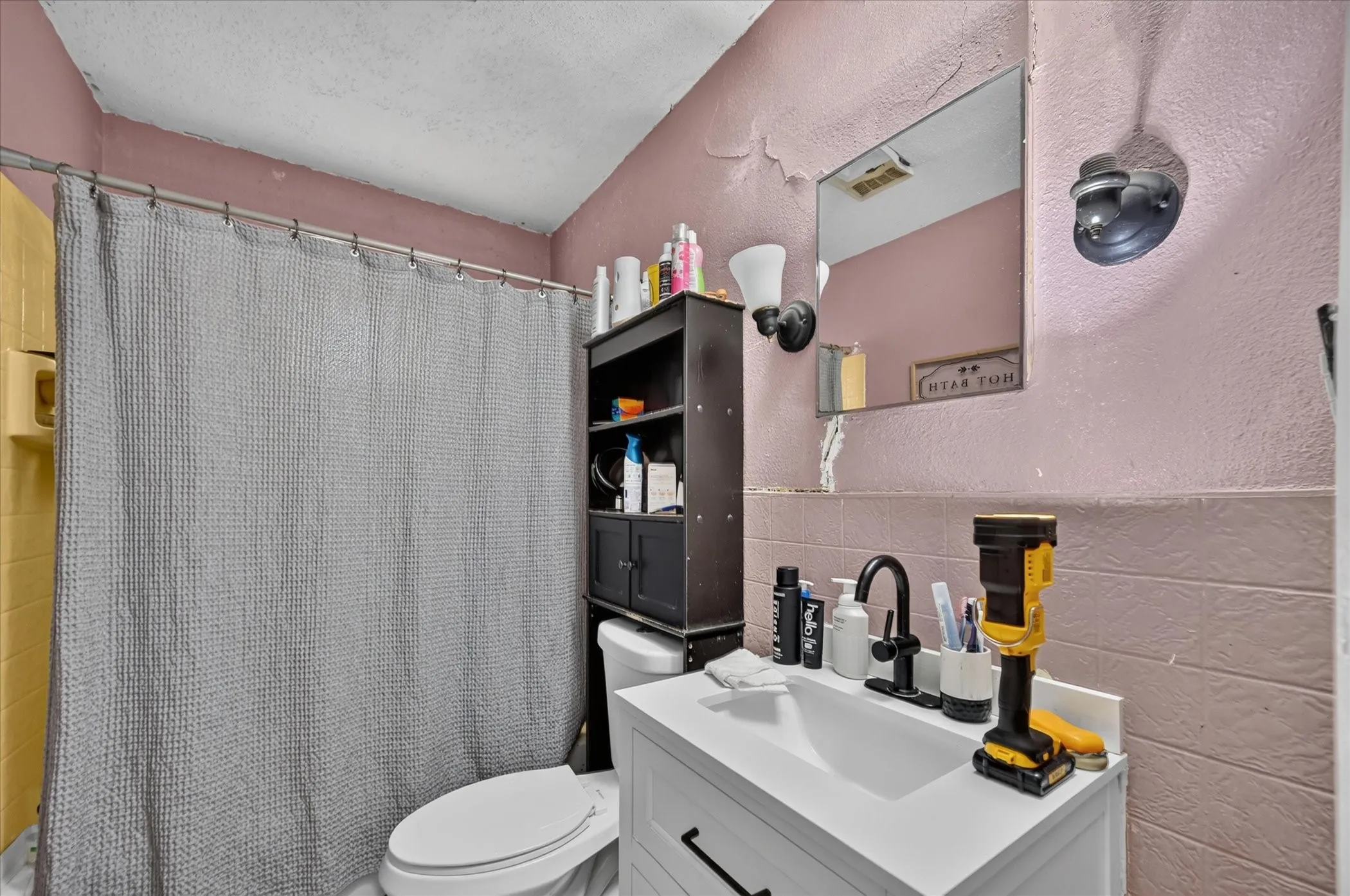White vanity with matte black faucet and hardware