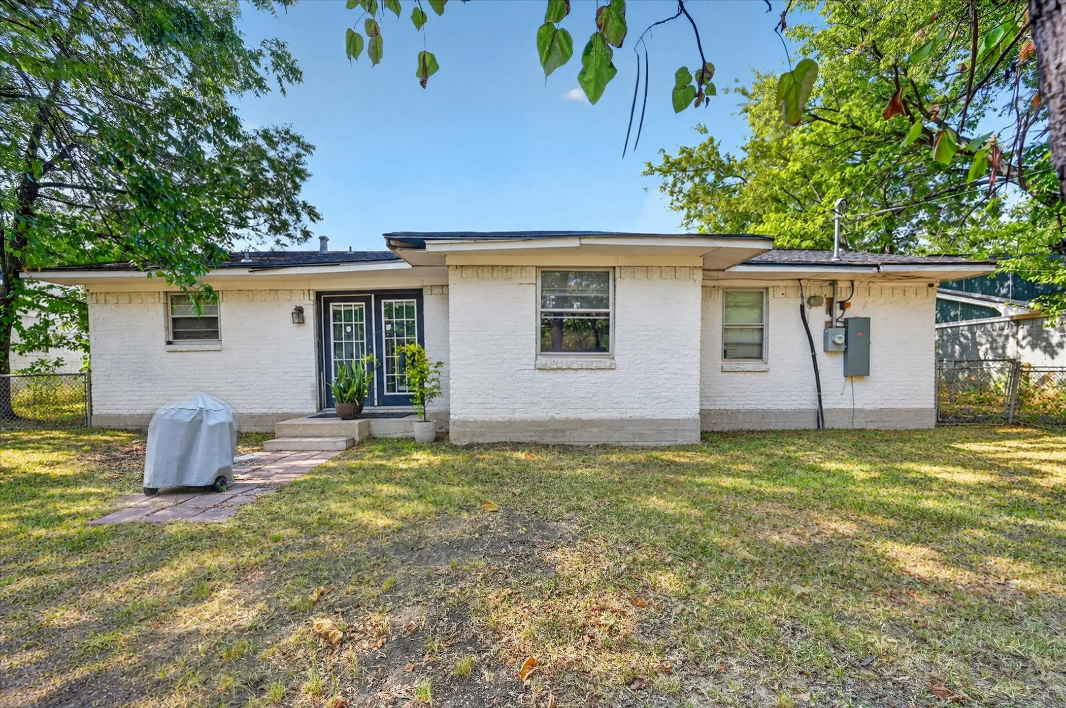 White stucco exterior with a dark trim roofline