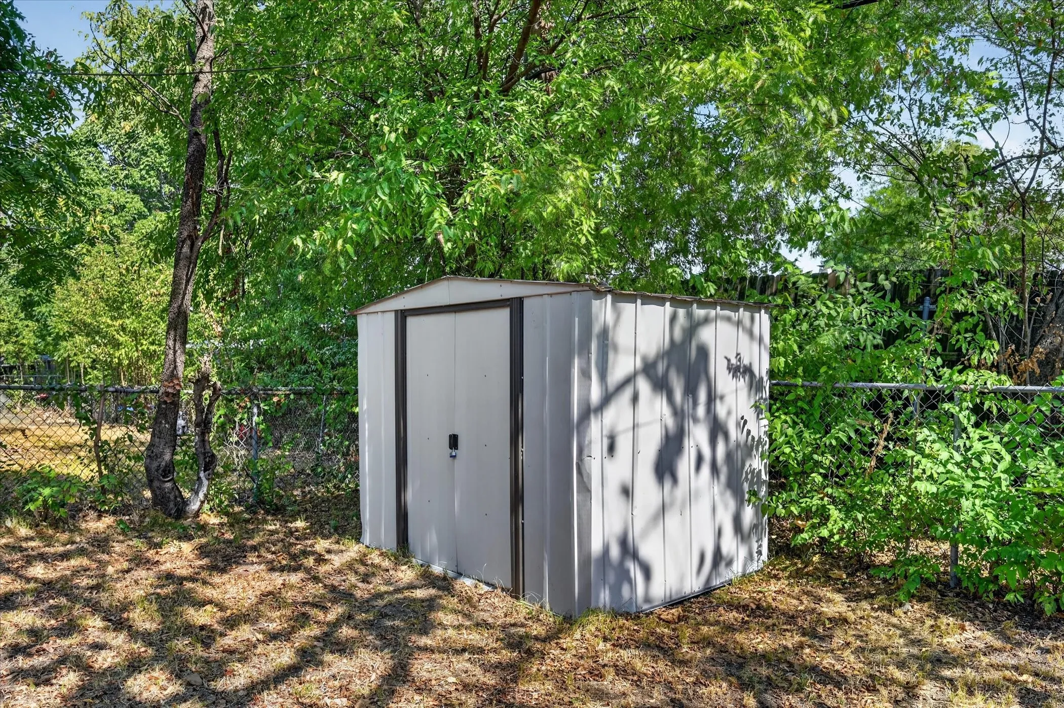 Metal utility shed with a gable roof