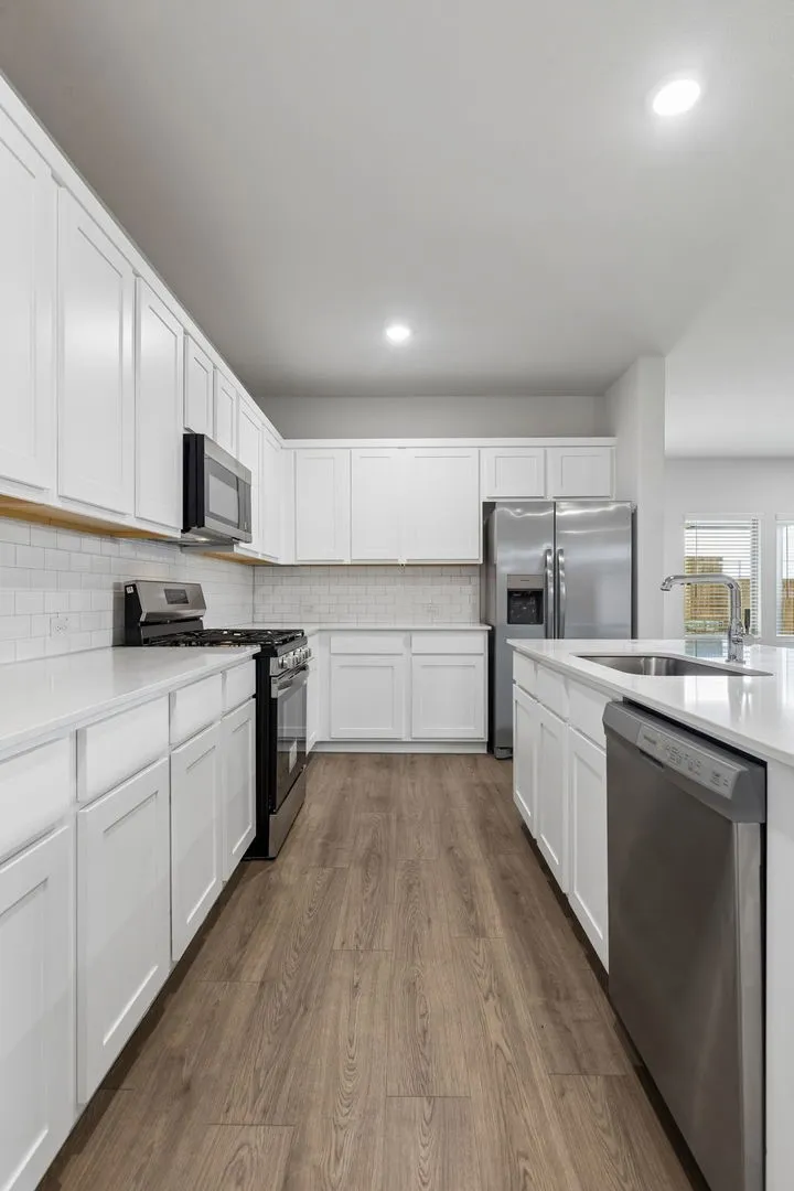 Kitchen in the Oscar home plan by Trophy Signature Homes – REPRESENTATIVE PHOTO