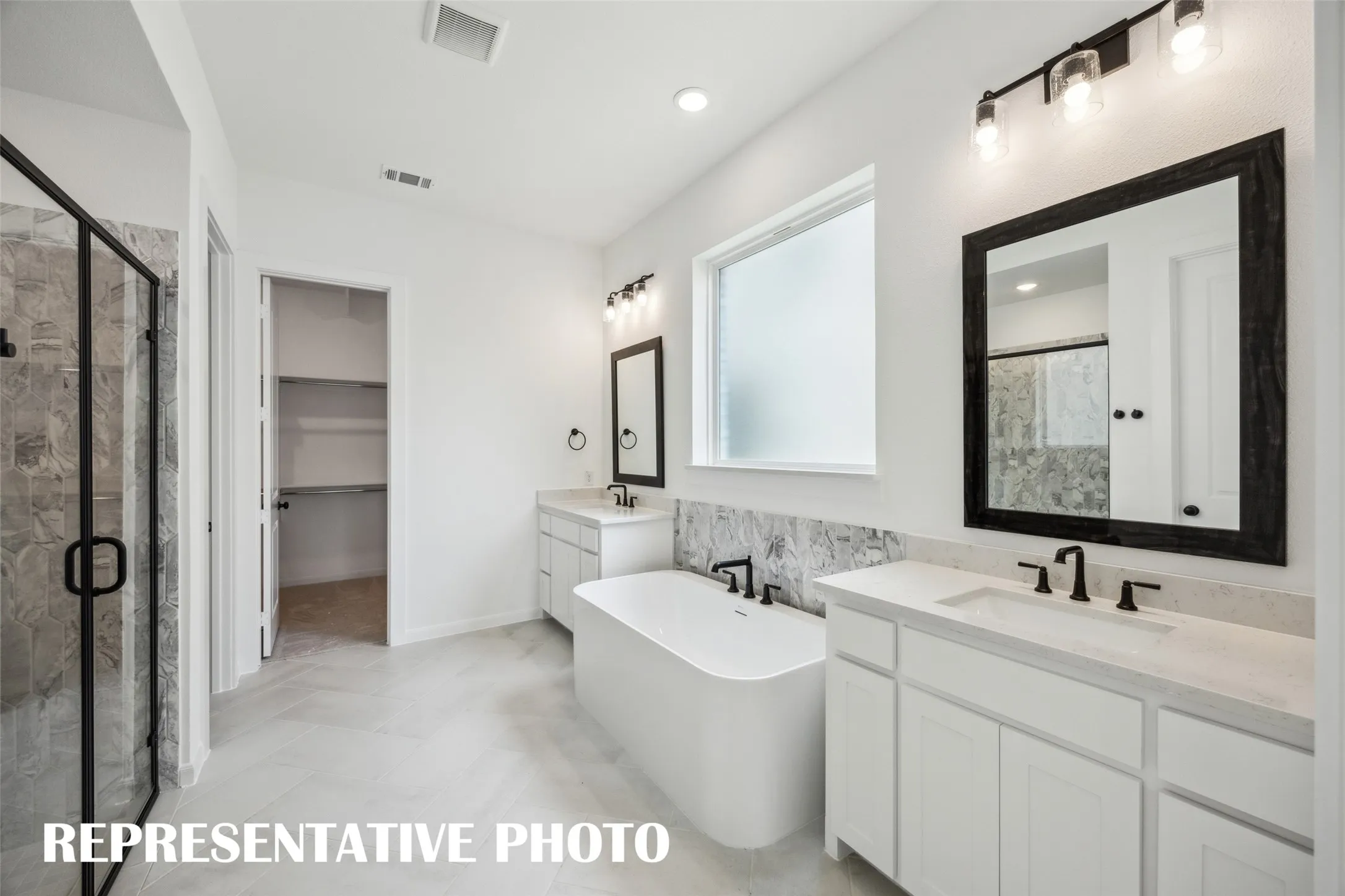 An owner's bath designed with two in mind! REPRESENTATIVE PHOTO