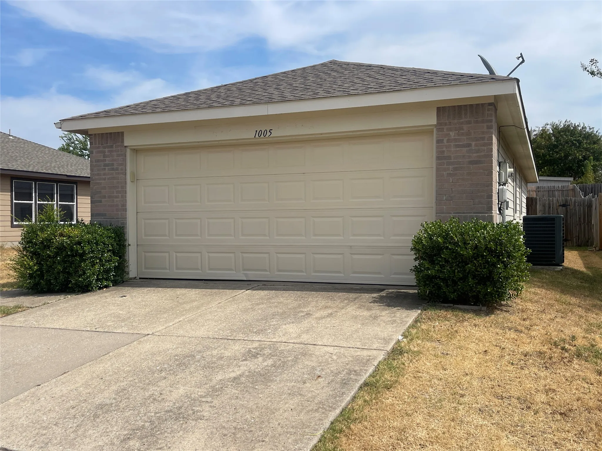 Brick and siding exterior with a two-car garage