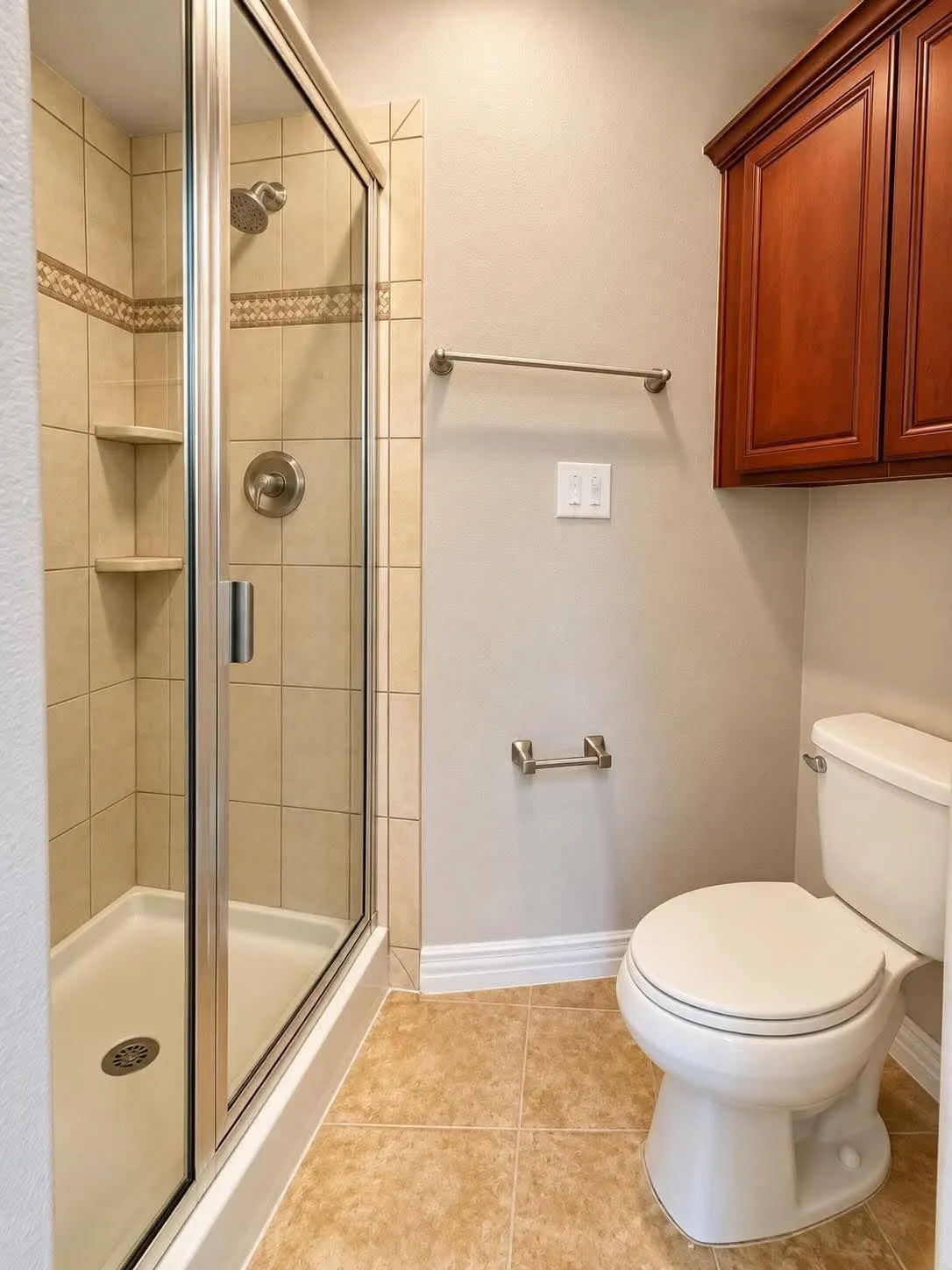 Glass-enclosed shower with tiled walls and built-in shelving