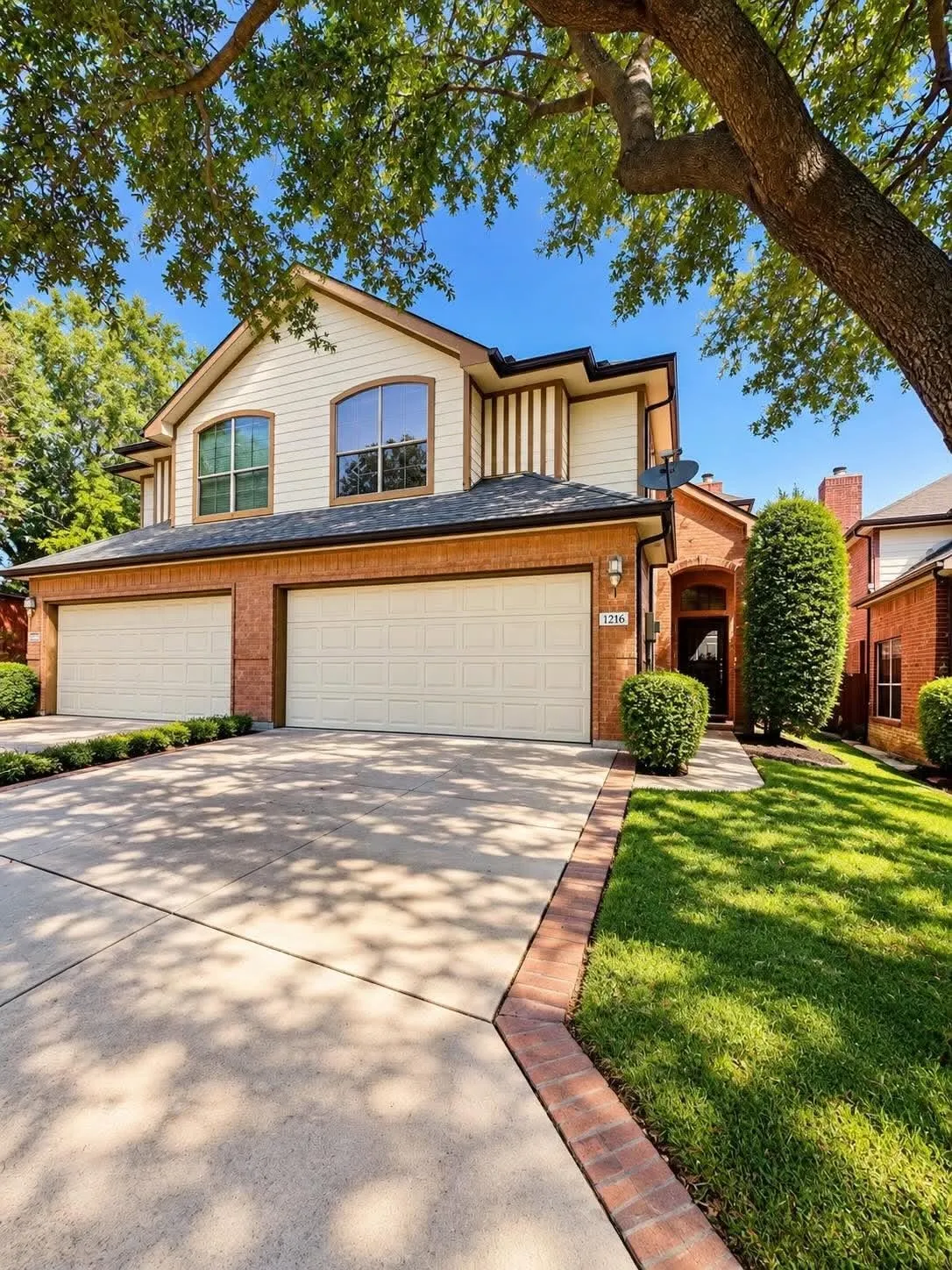Two-story residence featuring a brick and siding exterior with arched windows