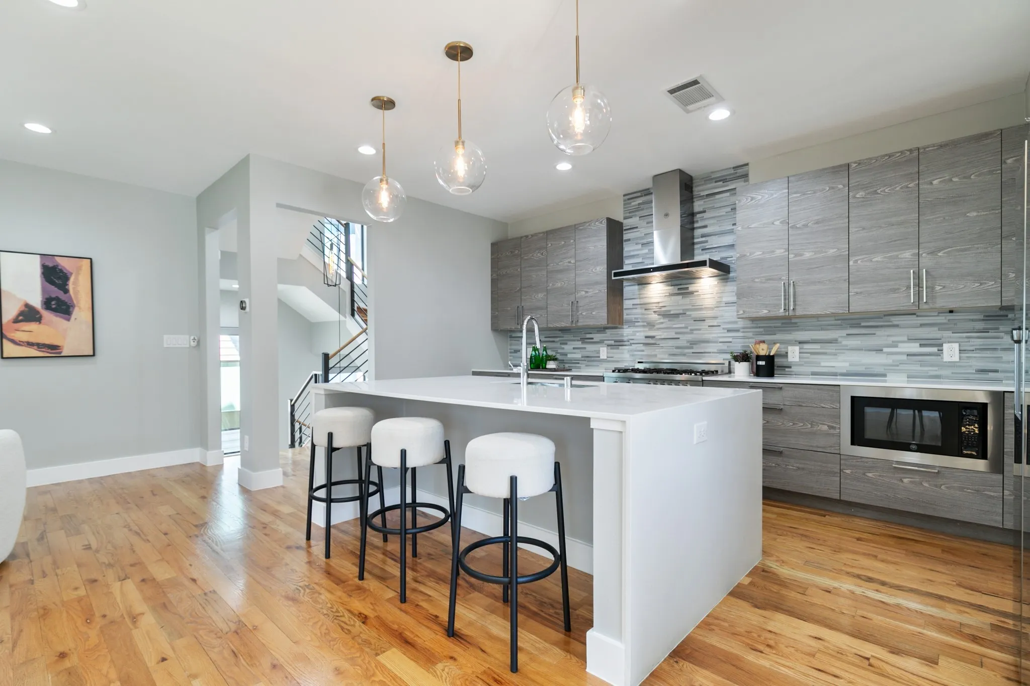 Gourmet kitchen featuring a central island, light wood-finish flooring, recessed lighting, and stainless steel appliances