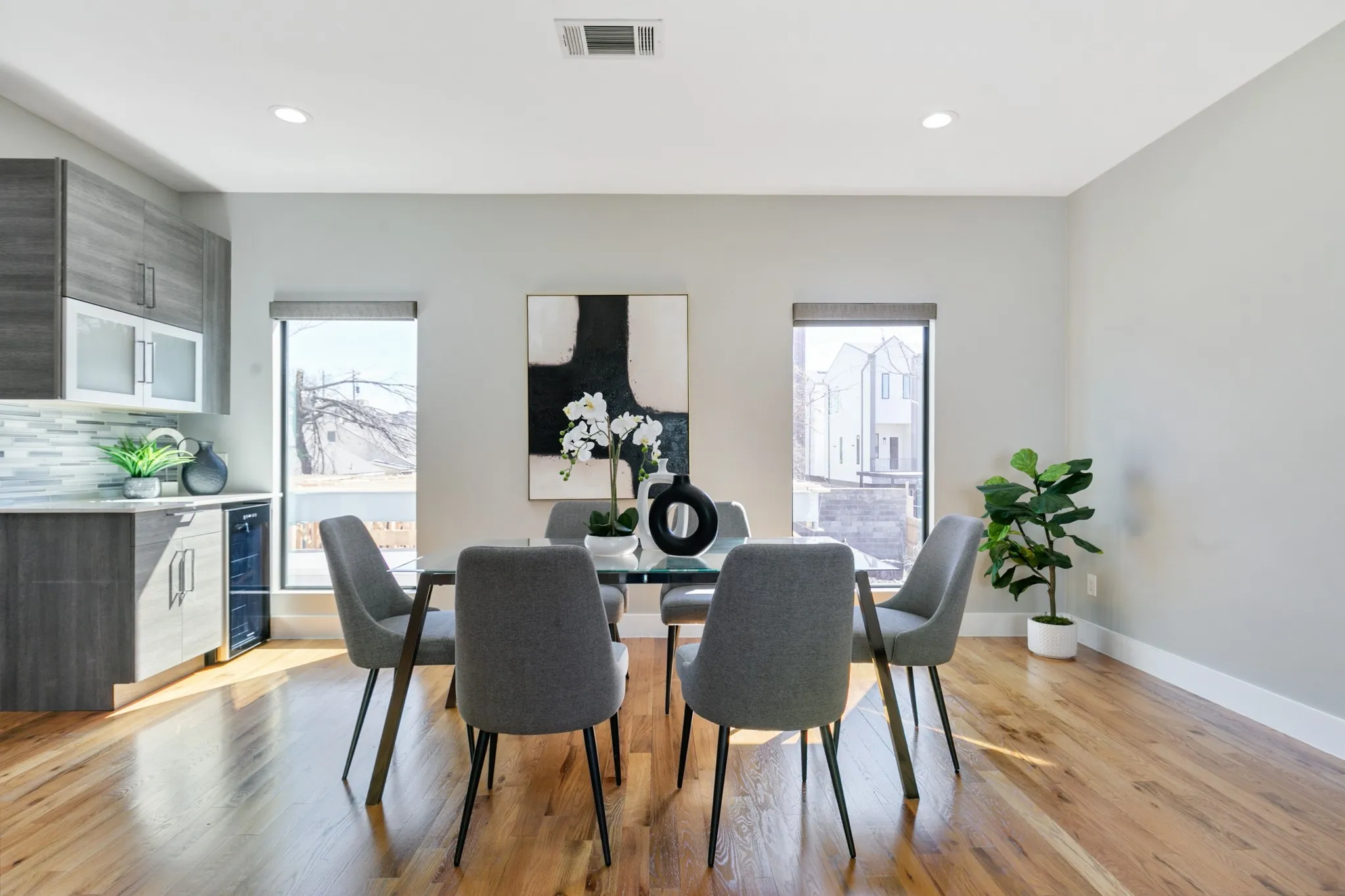Hardwood-style flooring, recessed lighting, and a built-in beverage refrigerator
