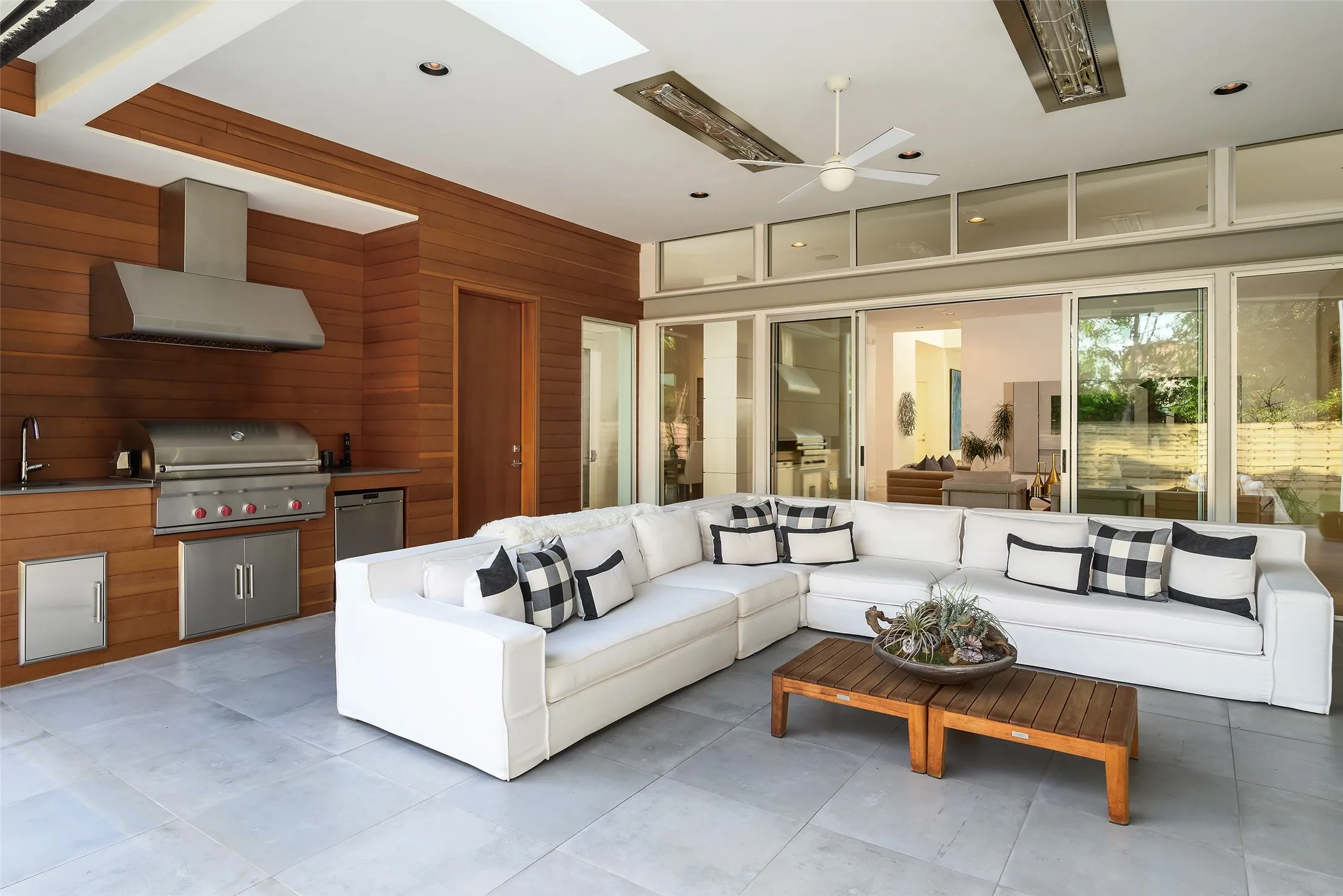 Covered patio with grilling area, heaters and automatic screens