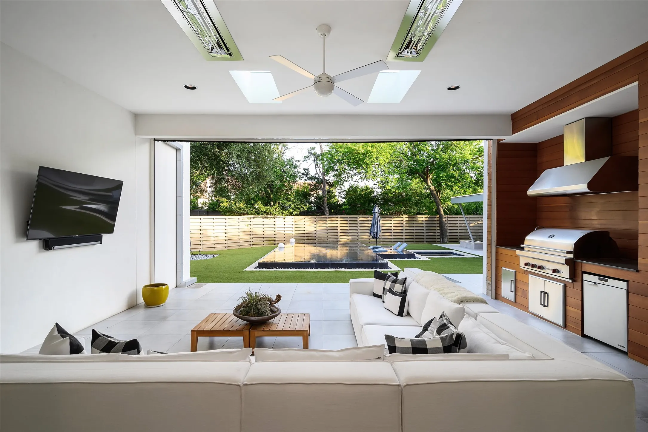 View to pool and Cabana from covered patio with grilling area, heaters and automatic screens