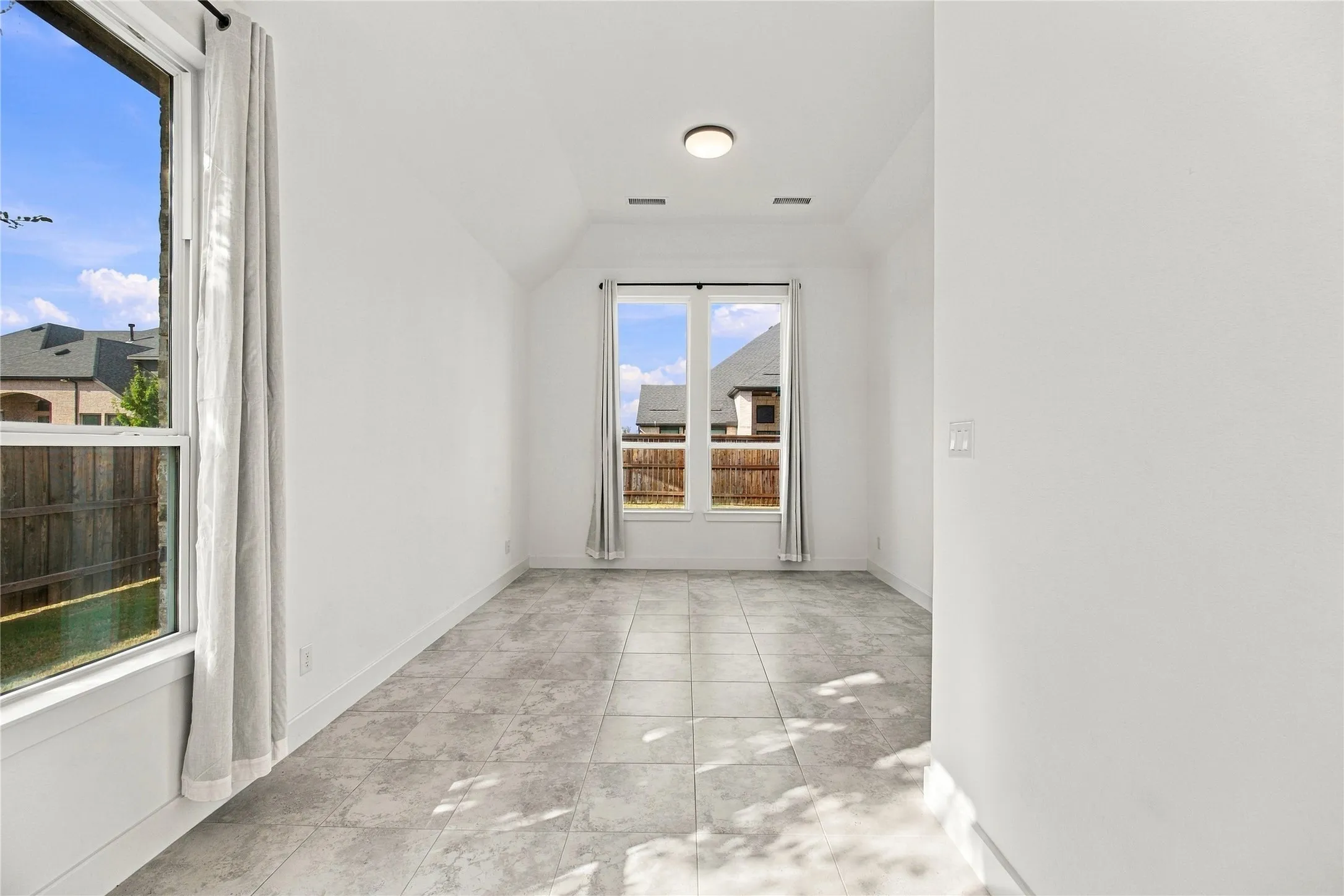 Bright, light-filled sitting area and expansive windows flooding the space with natural light