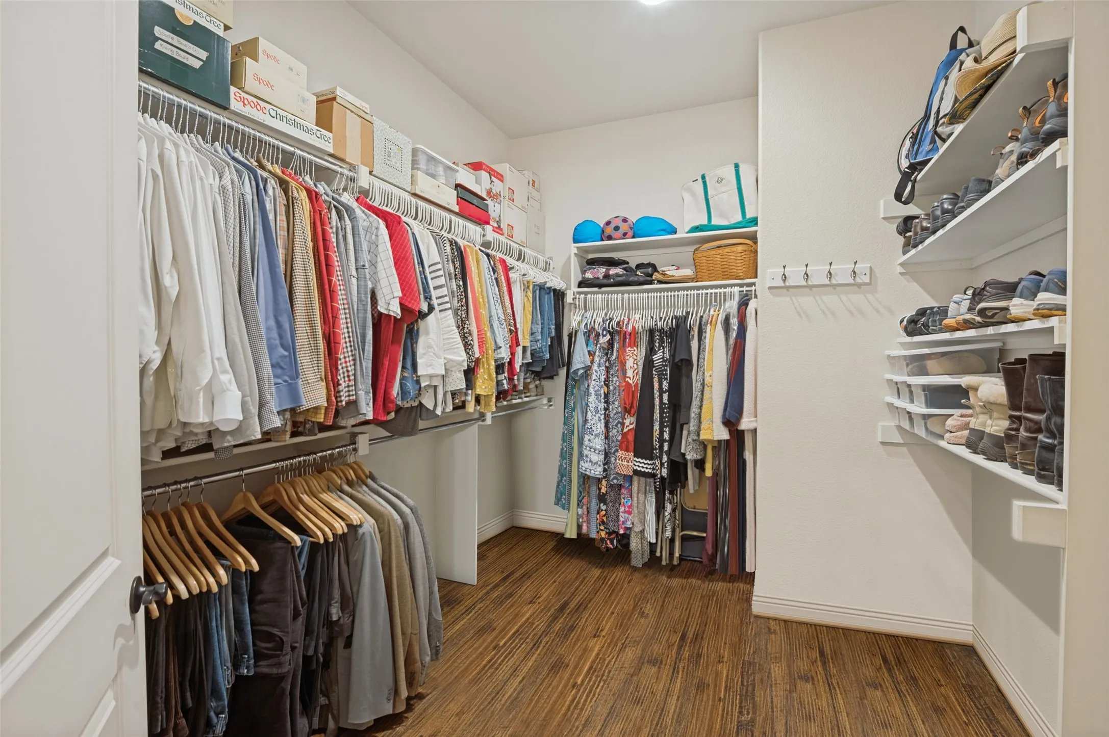 Walk in closet with wood floors