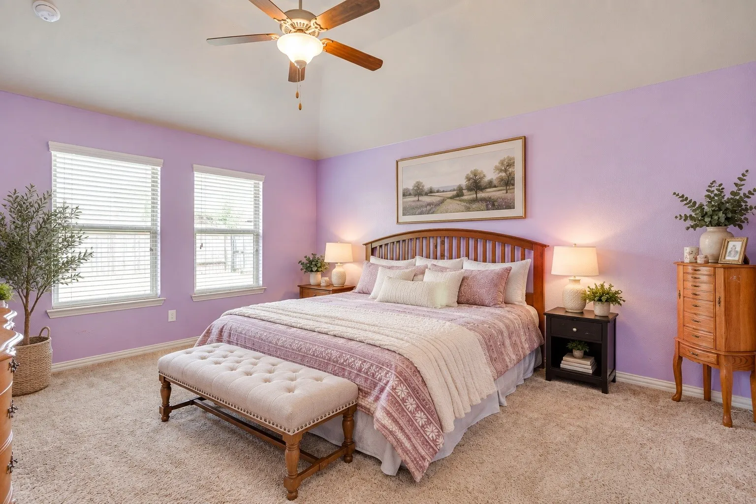 Vaulted ceiling with a ceiling fan, two windows, wood-finish bed frame, and wall-to-wall carpeting. Picture virtually edited