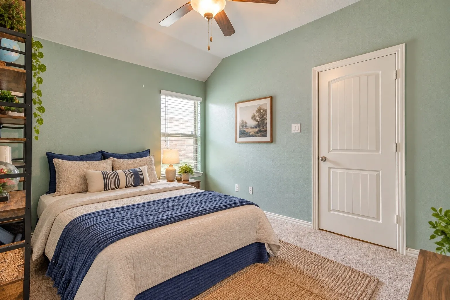 Vaulted ceiling with a ceiling fan, window with blinds, paneled door, and carpeted flooring - Photo virtually edited