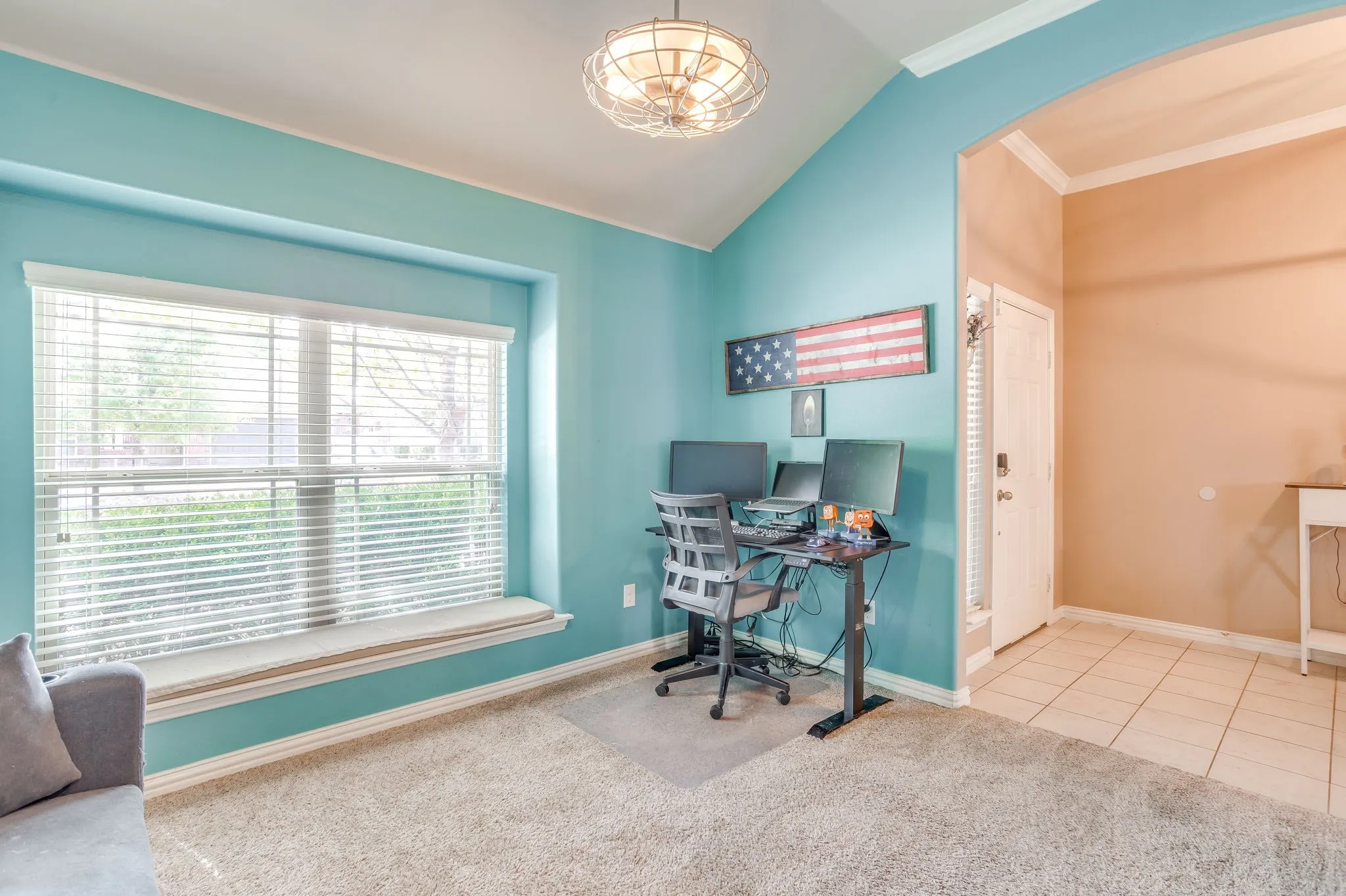 Vaulted ceilings and a large window with a built-in bench seat