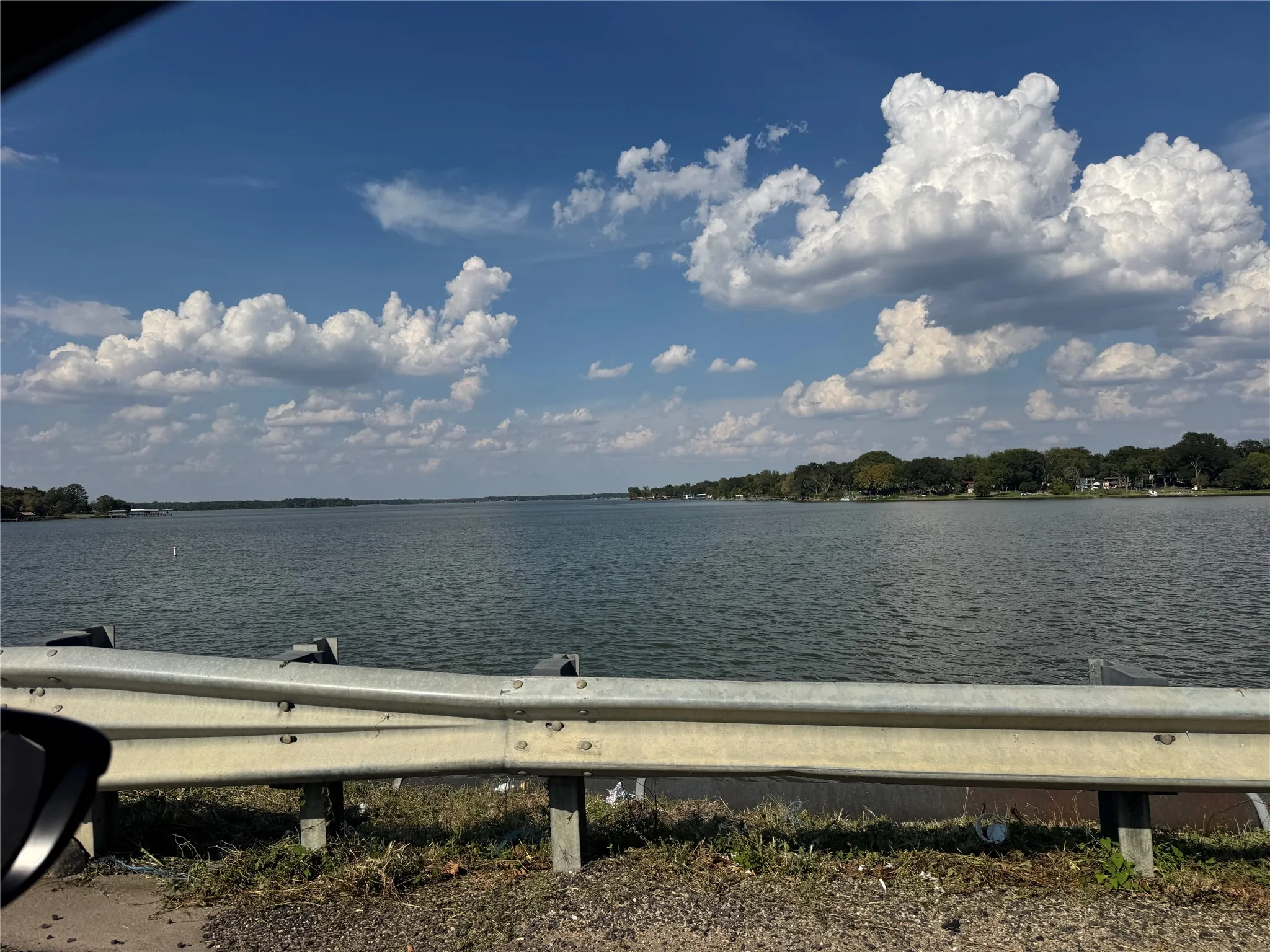 Expansive water frontage with mature trees along the shoreline