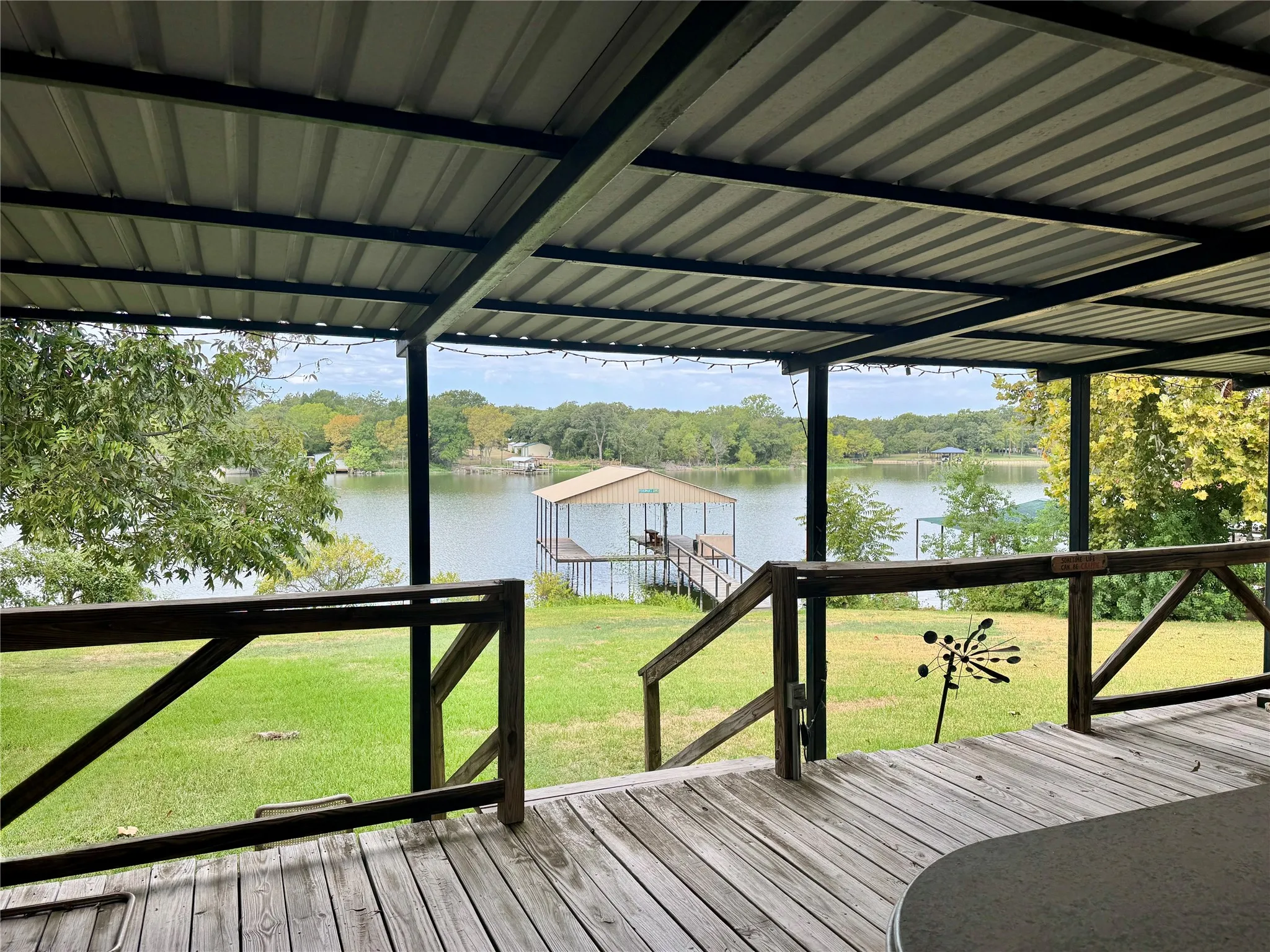 Expansive wooden deck with an overhead metal roof structure