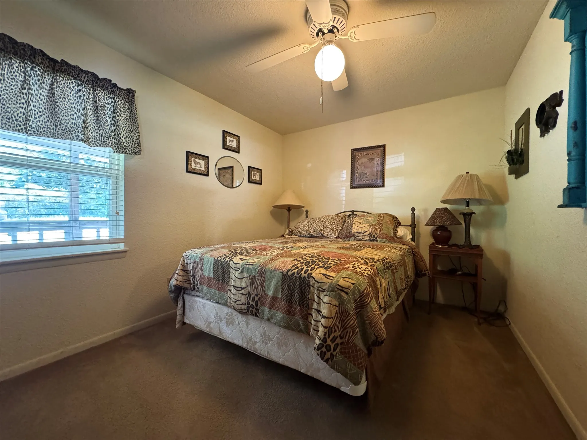Wall-to-wall carpeted flooring, window with blinds, and ceiling fan with integrated lighting