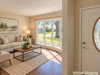 Wood-finish flooring with a multi-pane bay window, and a door featuring an oval leaded glass insert