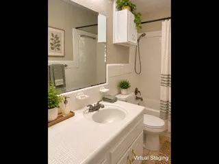 White vanity with integrated sink, rectangular mirror, and shower/tub combination