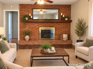 Brick fireplace with a brass-finish firebox, a wood mantel, and a mounted mirror