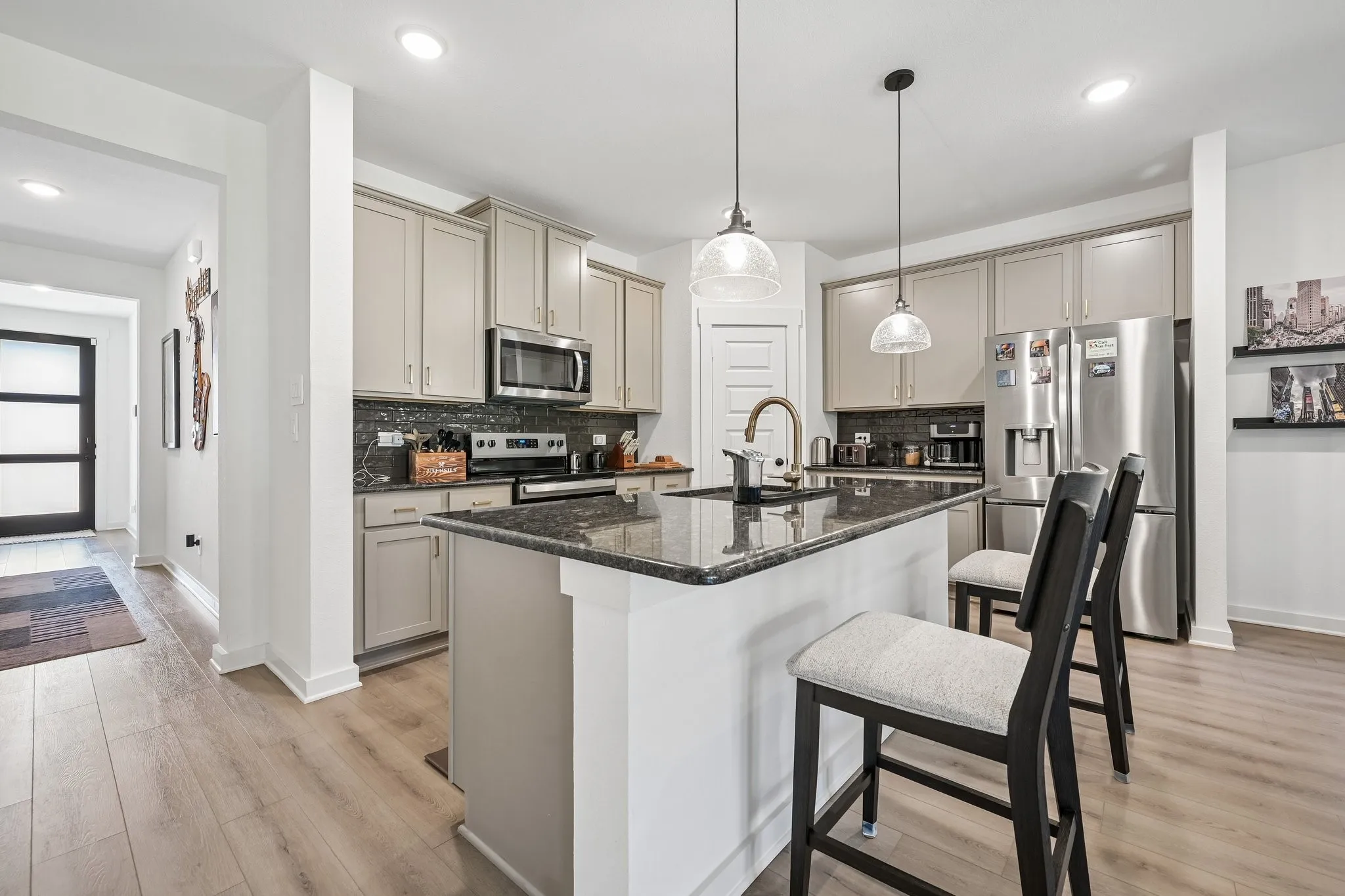 Wood-finish flooring, recessed lighting, and a ceiling fan create a comfortable atmosphere