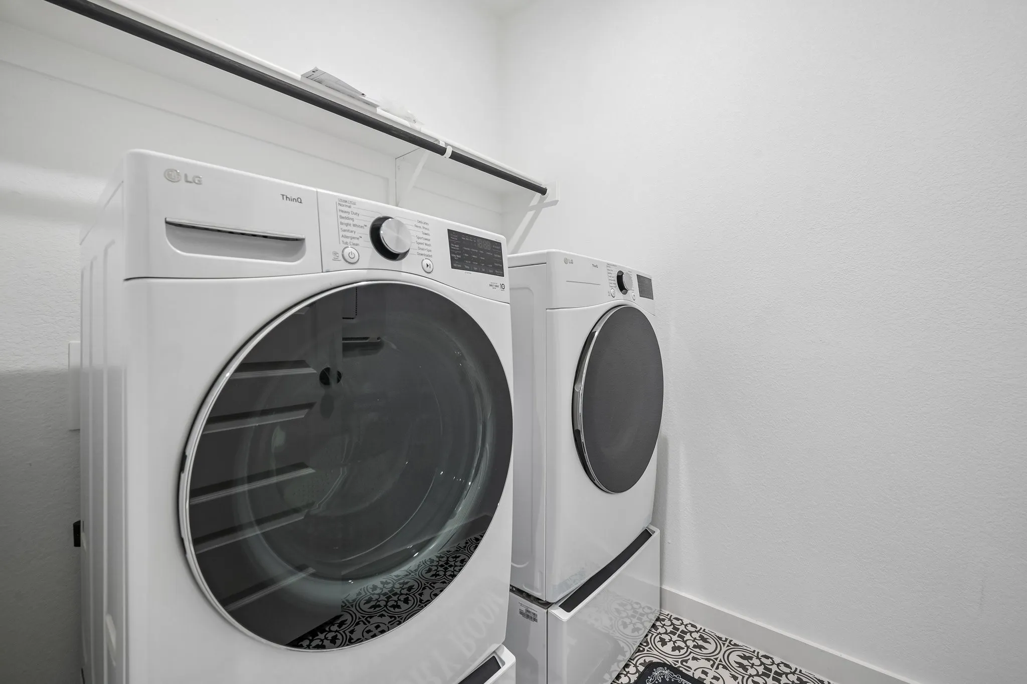 White wall-mounted shelving unit over laundry appliances