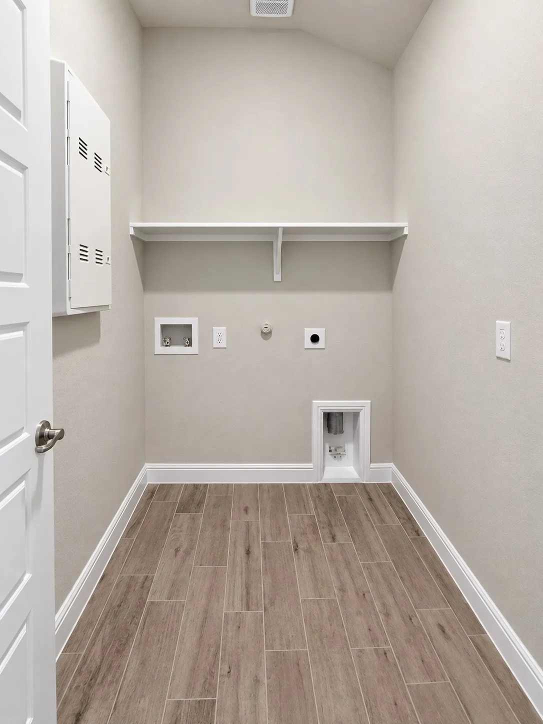 Wood-finish flooring, integrated wall shelving, and utility connections