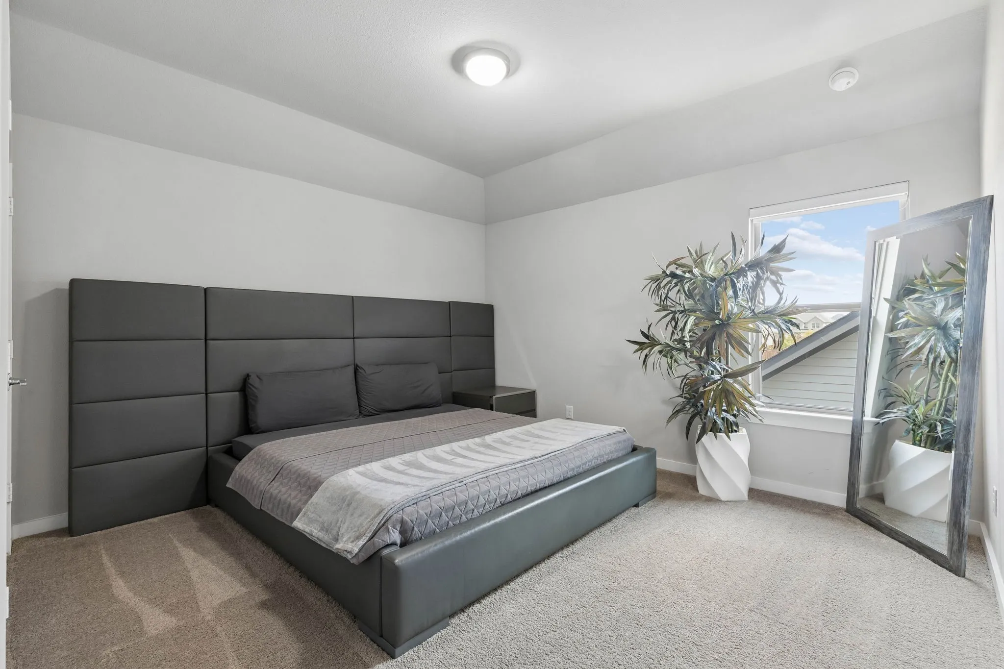 Recessed lighting and a window with white trim